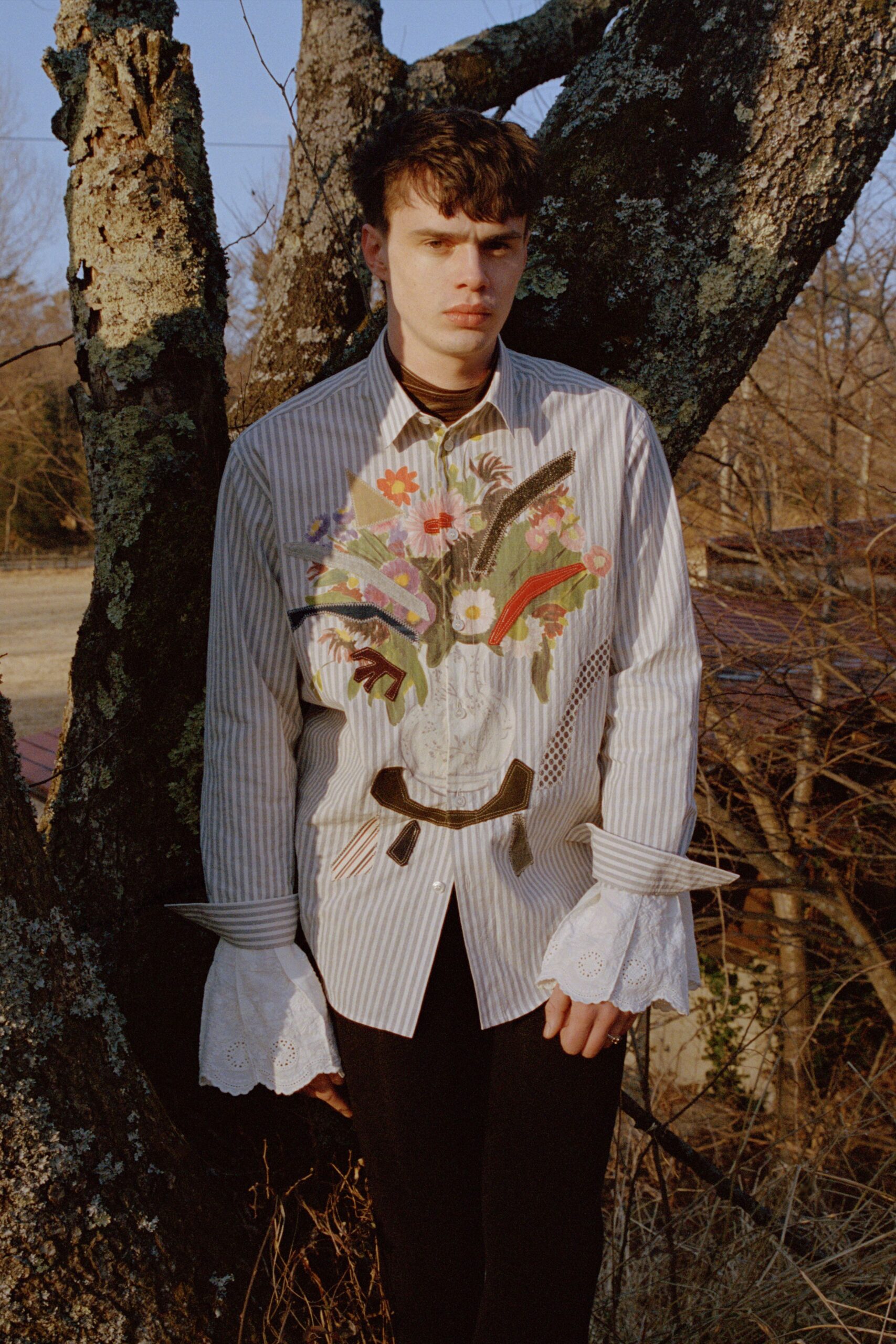 embroidered long-sleeve shirt with black pants
