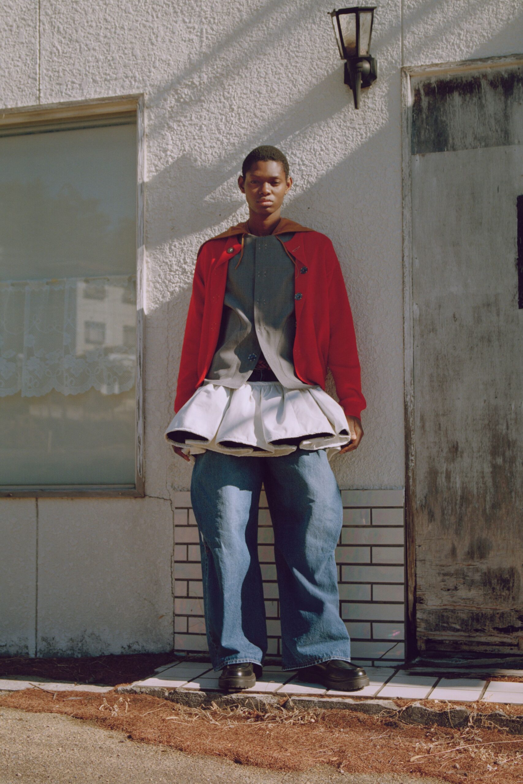 red jacket gray top white skirt blue pants black shoes