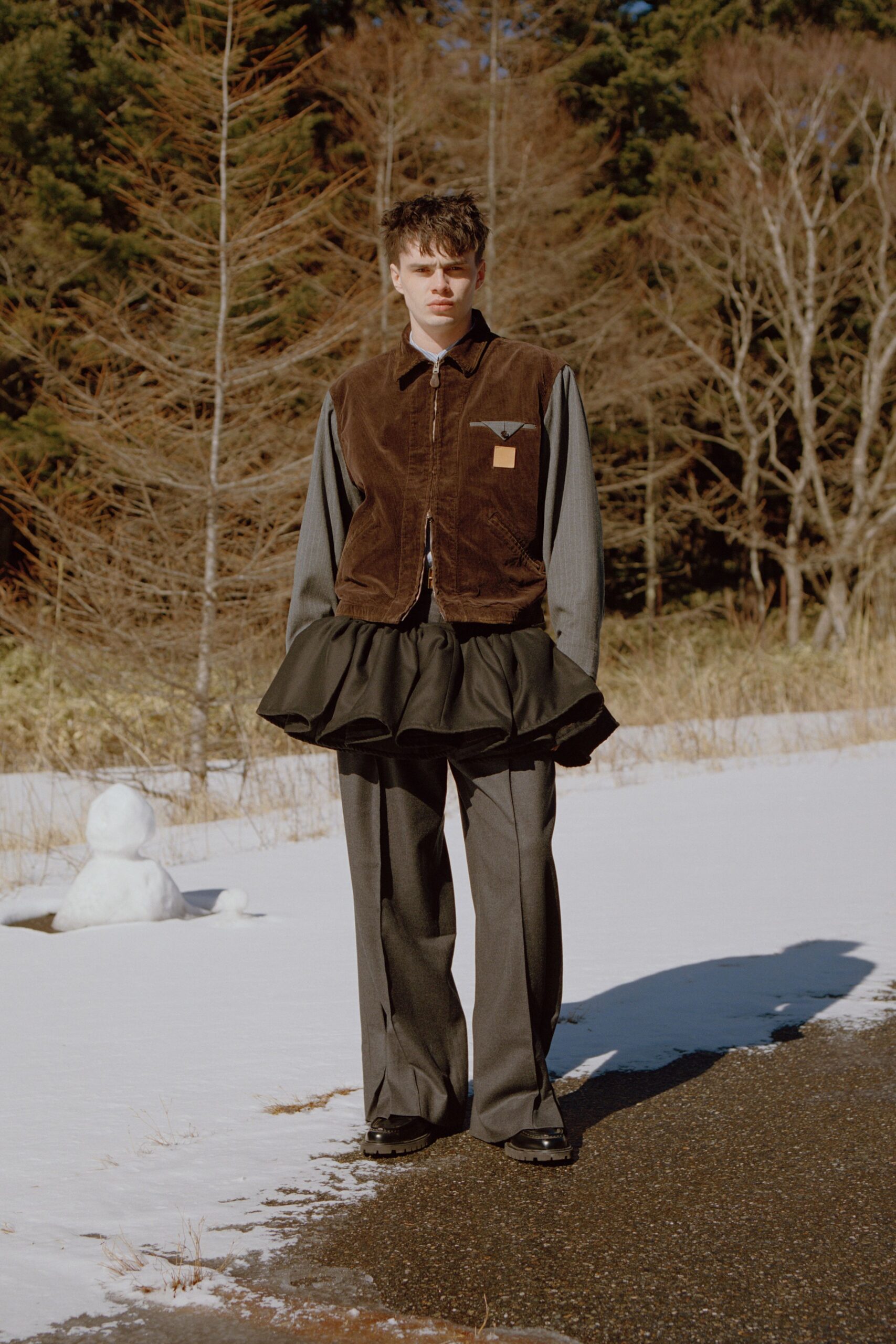 brown vest gray shirt black skirt