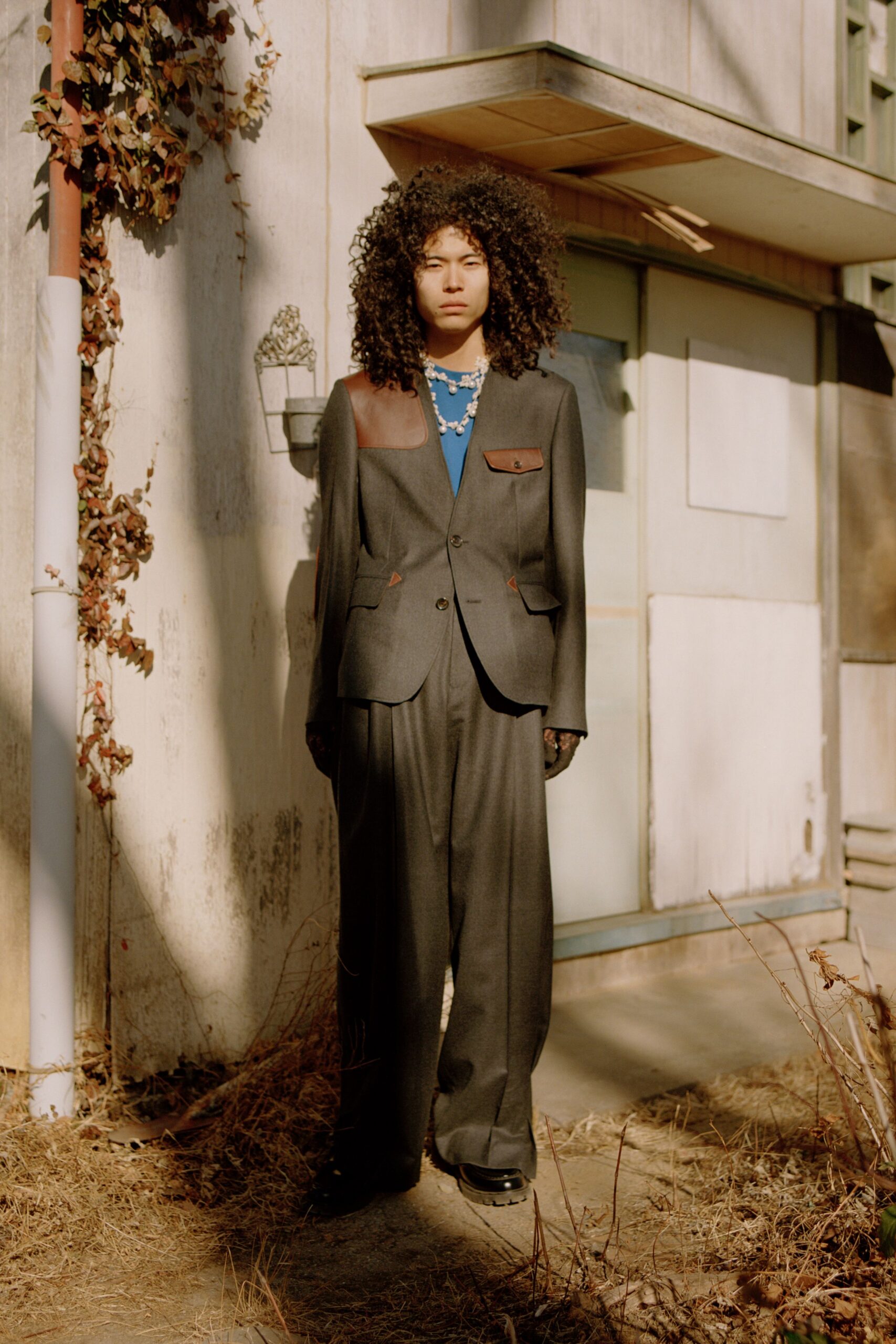 gray tailored suit with blue top
