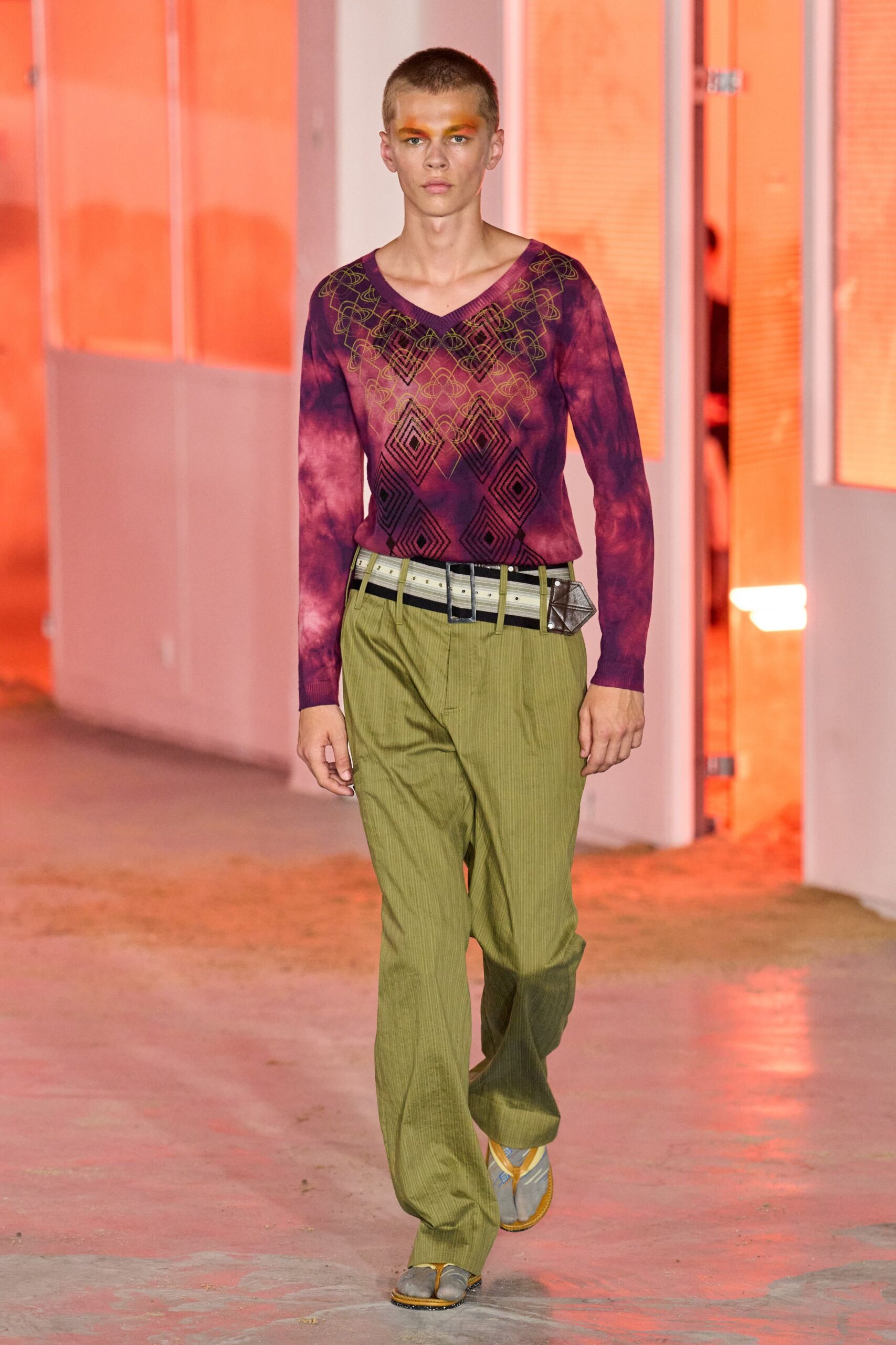 purple embroidered top with green pants