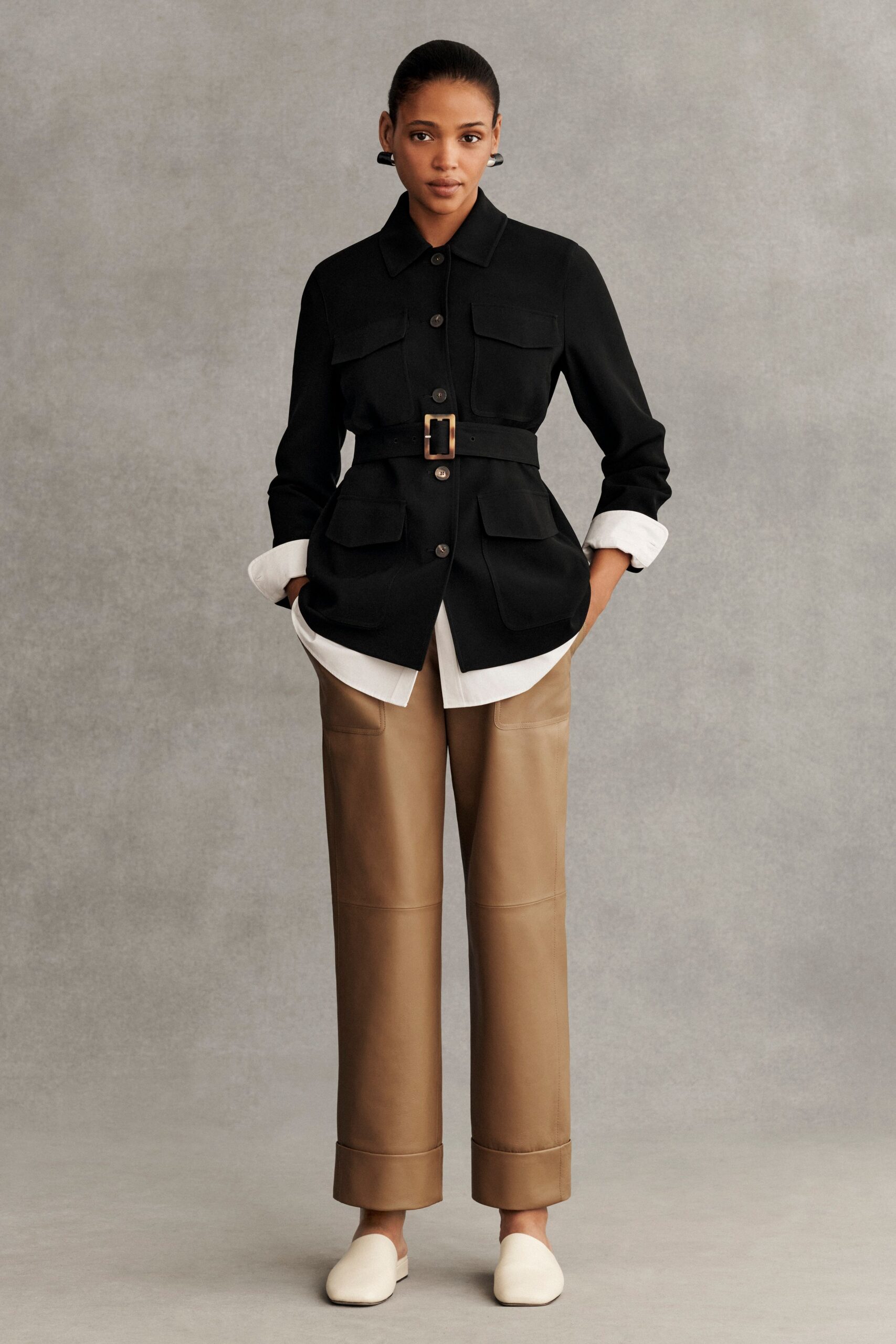 black jacket white shirt beige pants