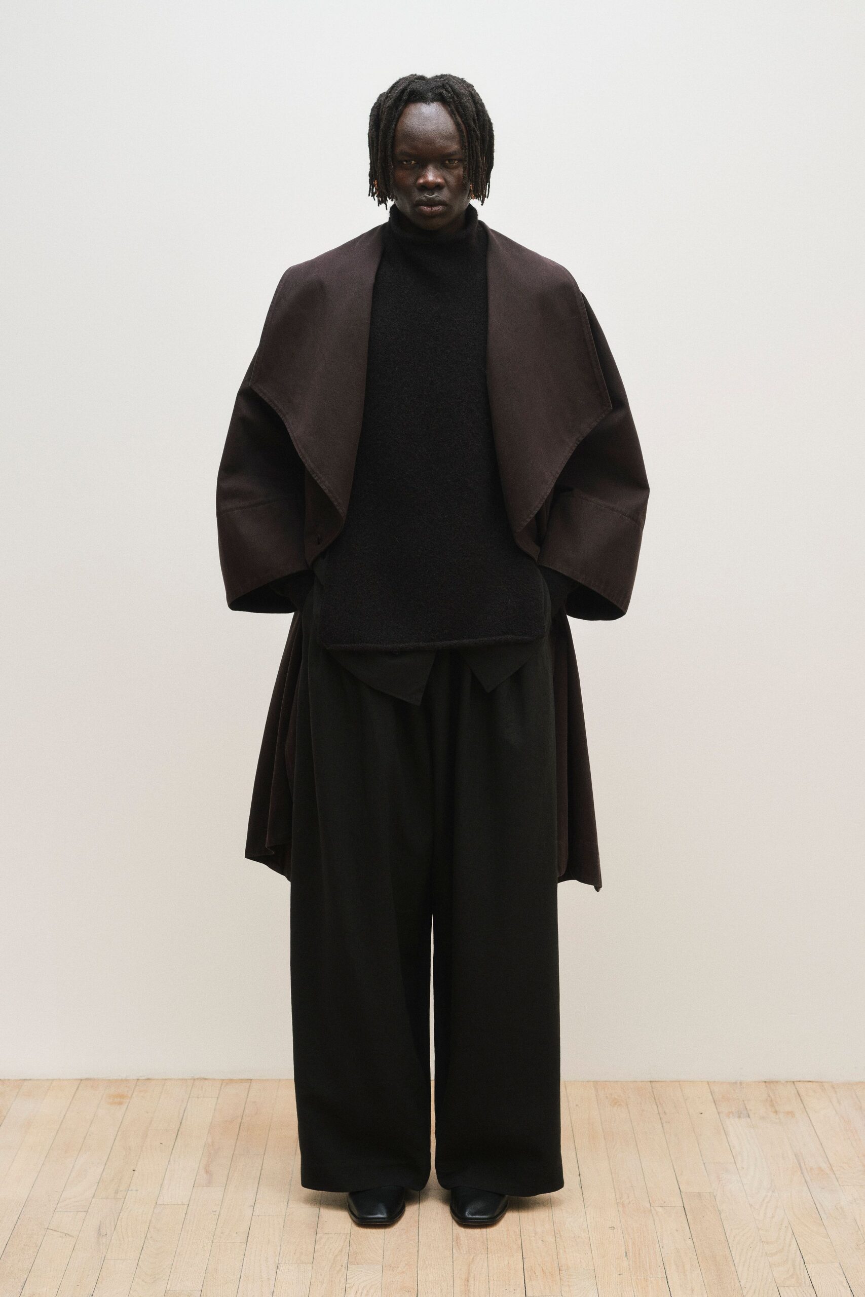 brown wool coat black sweater pants