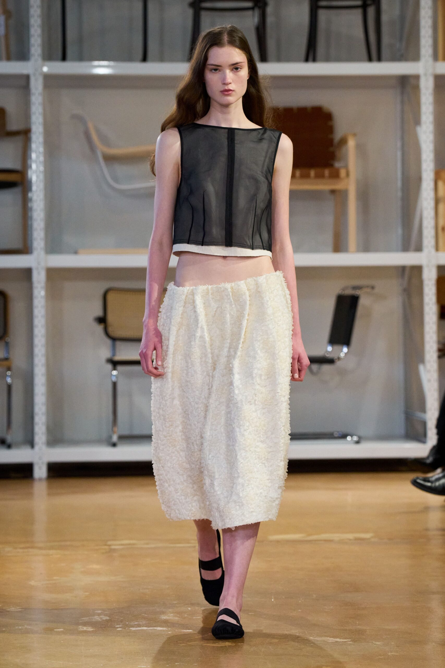 black leather sleeveless top and white midi skirt