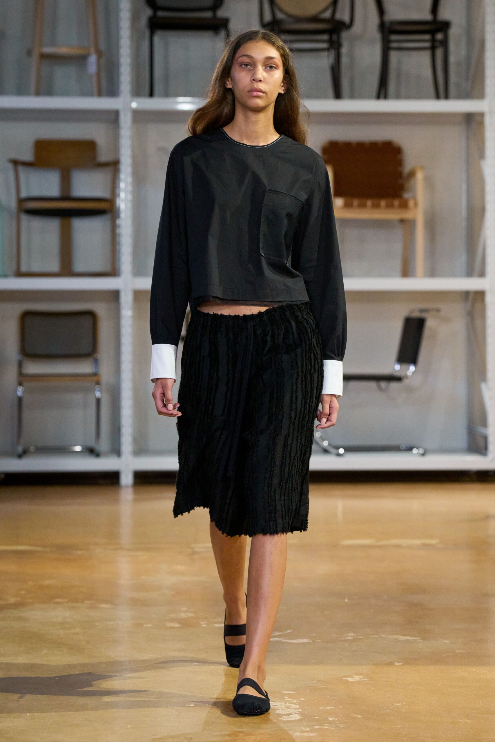 black relaxed top with pleated skirt