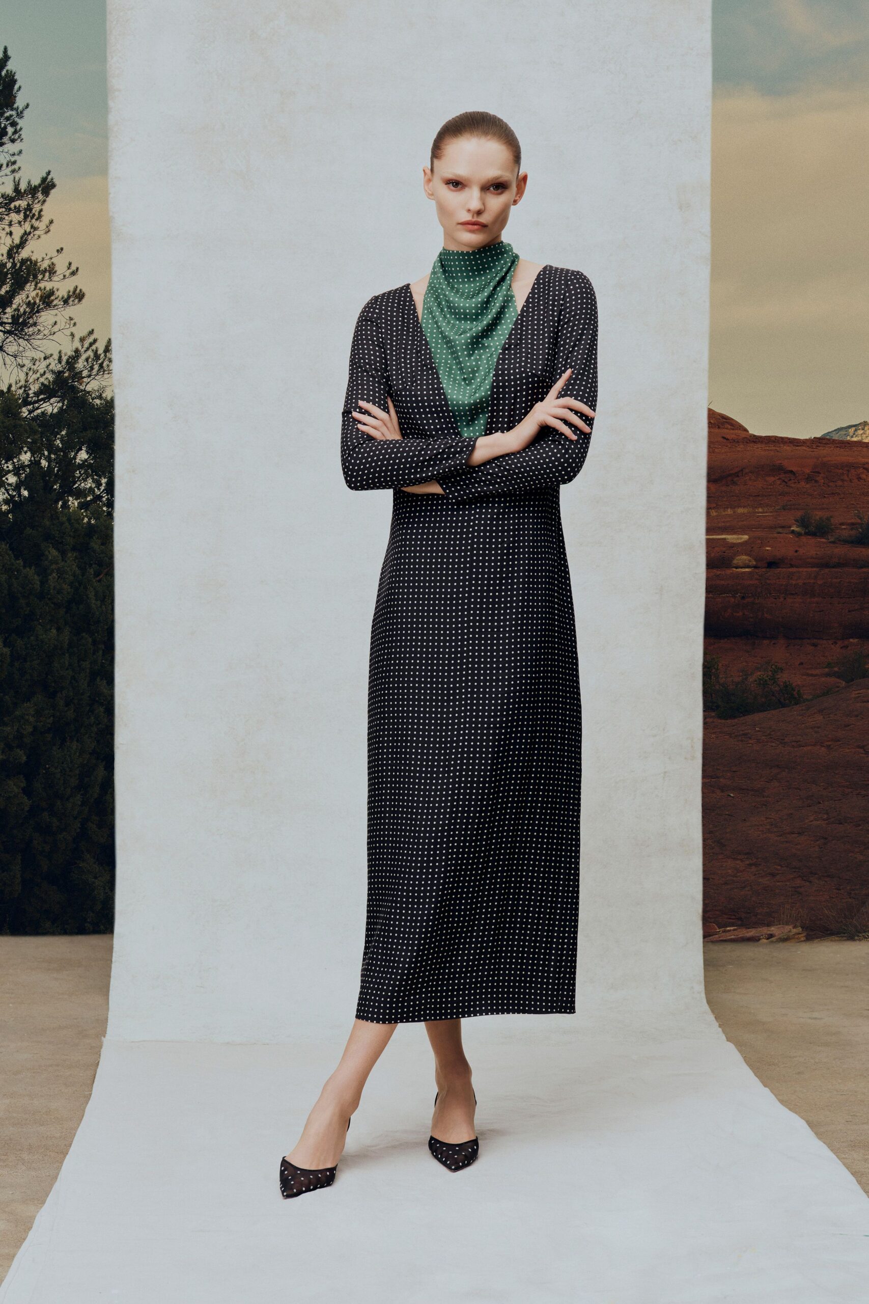 black polka-dot midi dress with green scarf