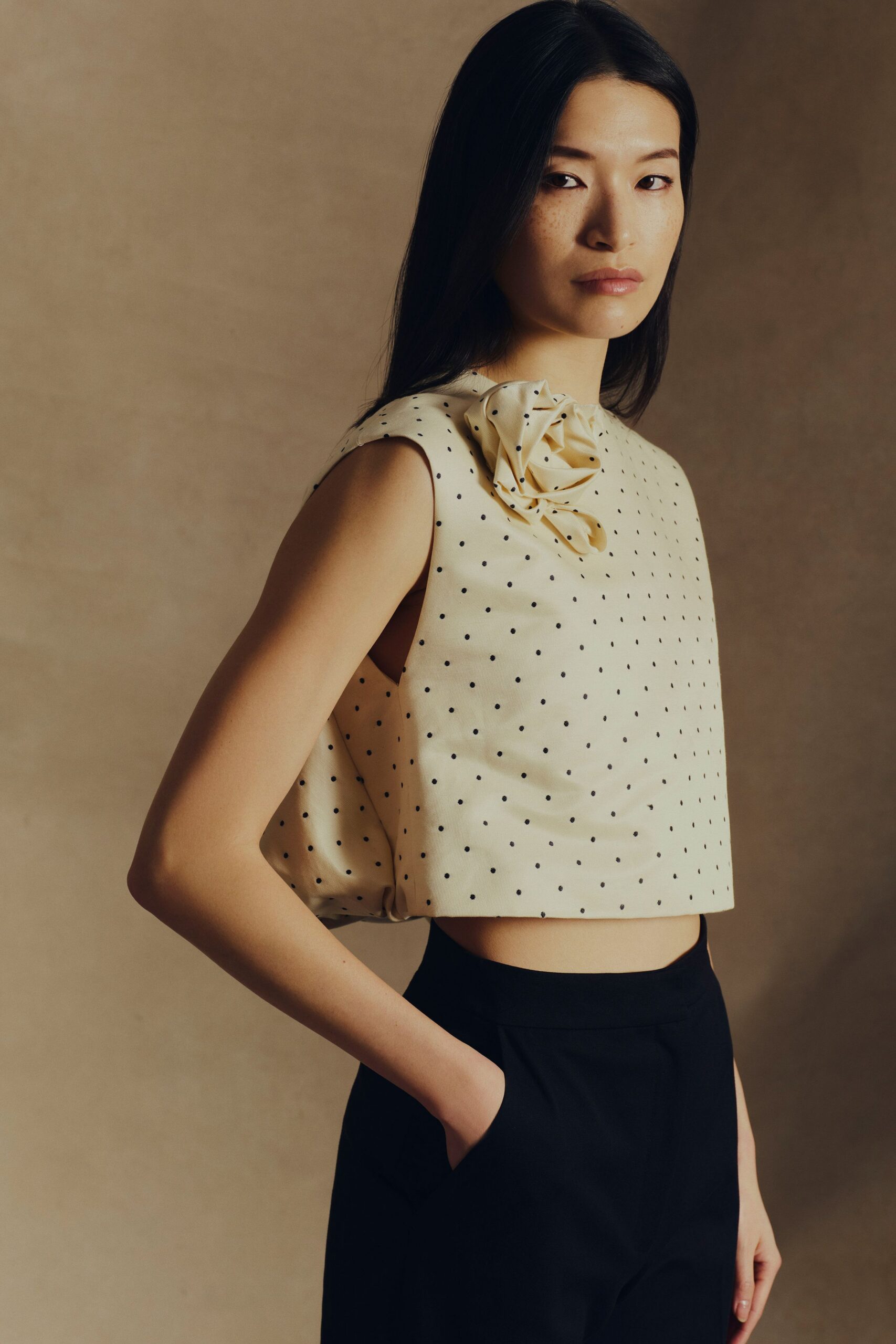 beige cotton sleeveless high-neck fitted polka-dot embellished top