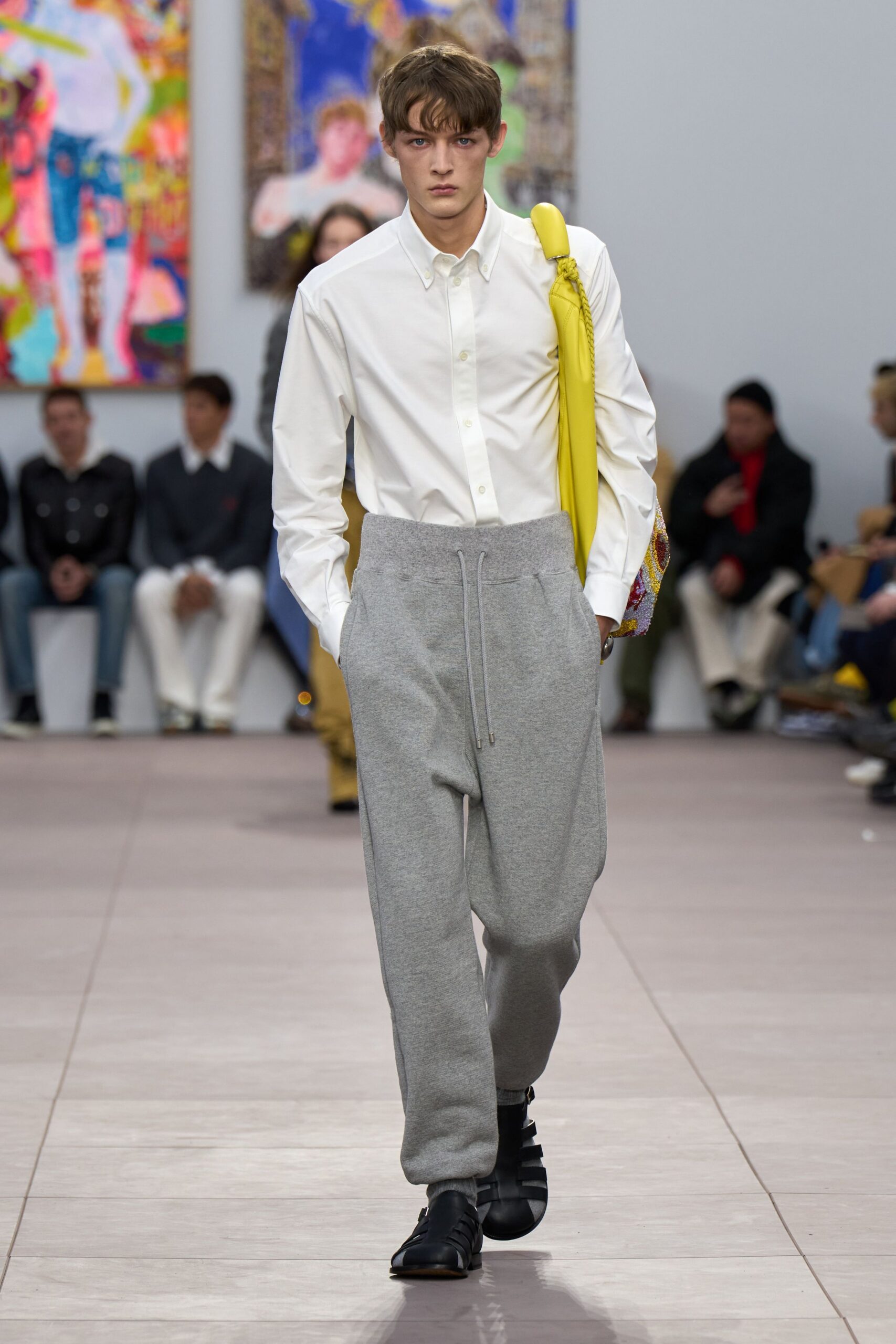 white shirt gray pants black shoes yellow bag