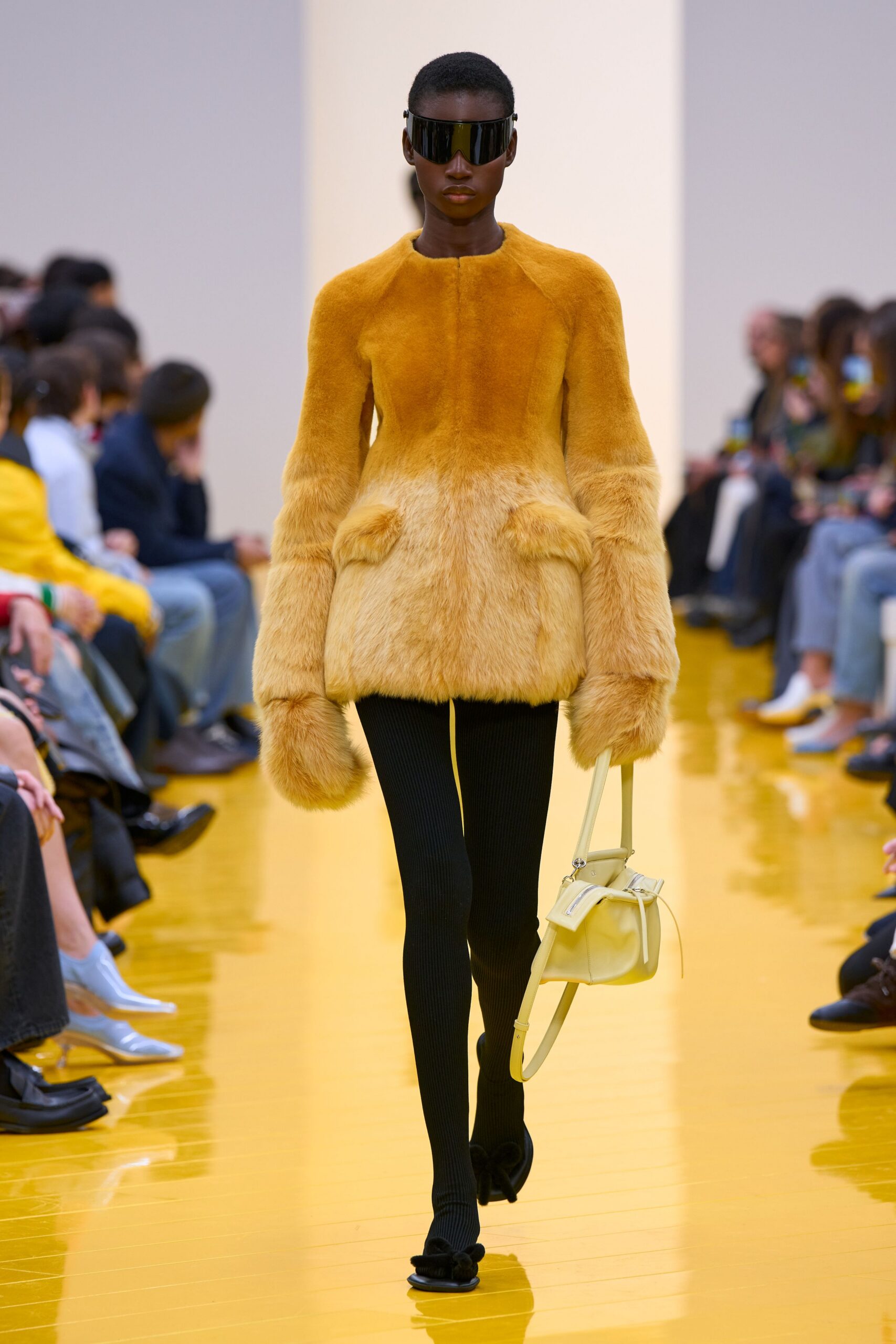 yellow fur coat with black pants