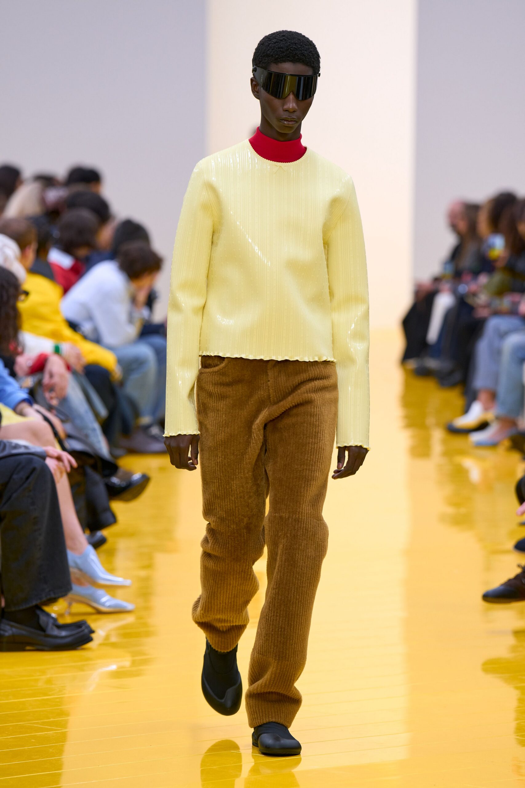 yellow pleated top with brown pants