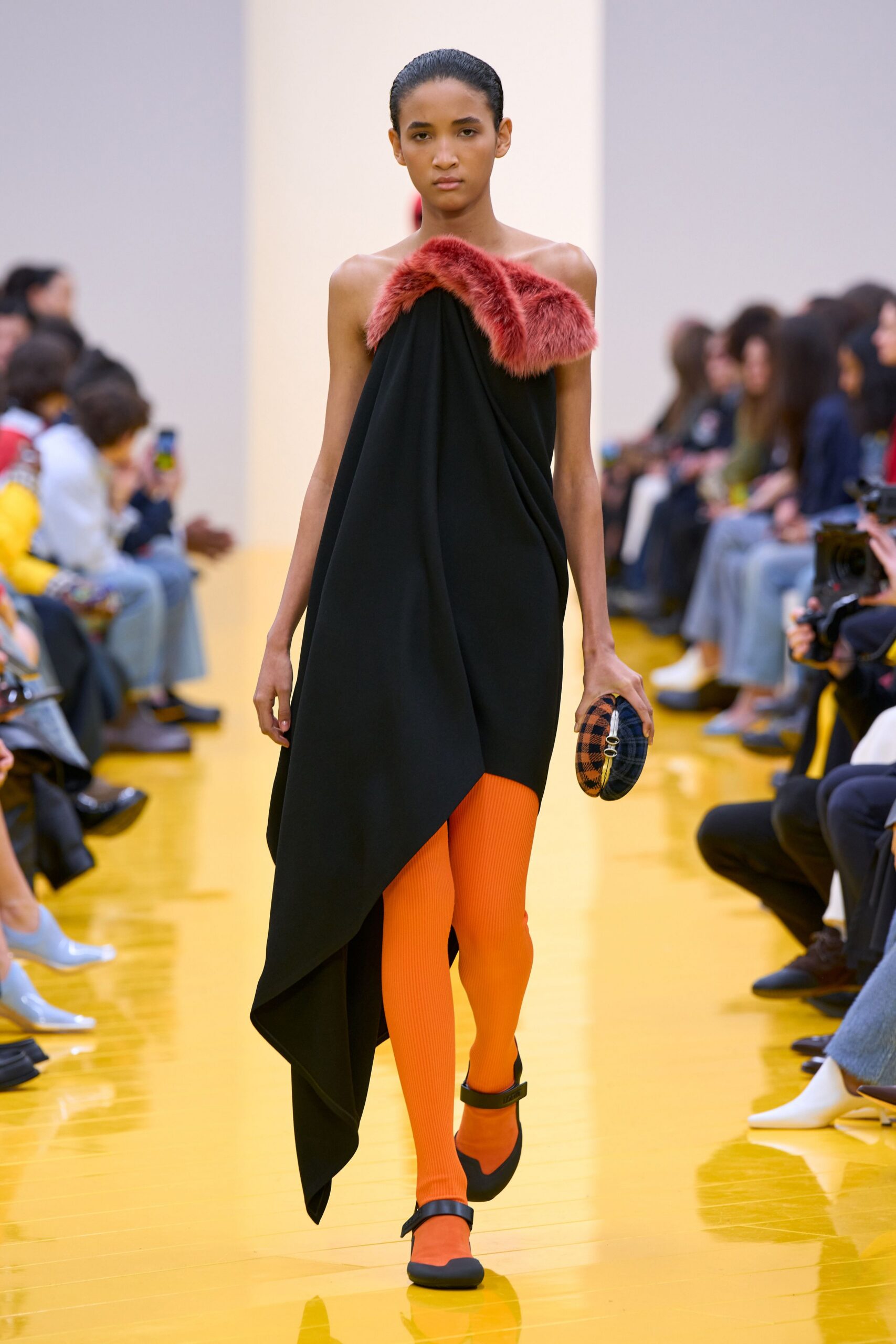 black asymmetric dress with orange leggings