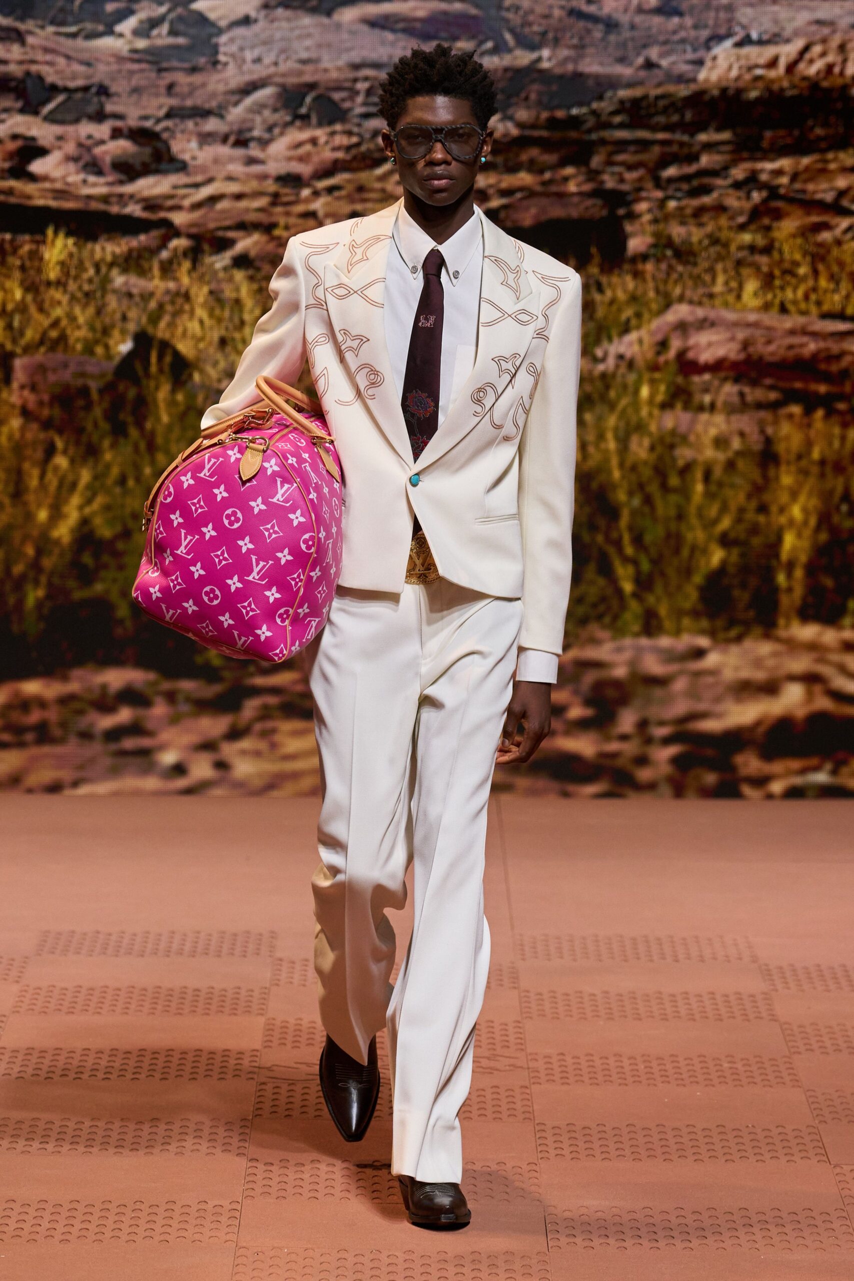white tailored suit with pink bag