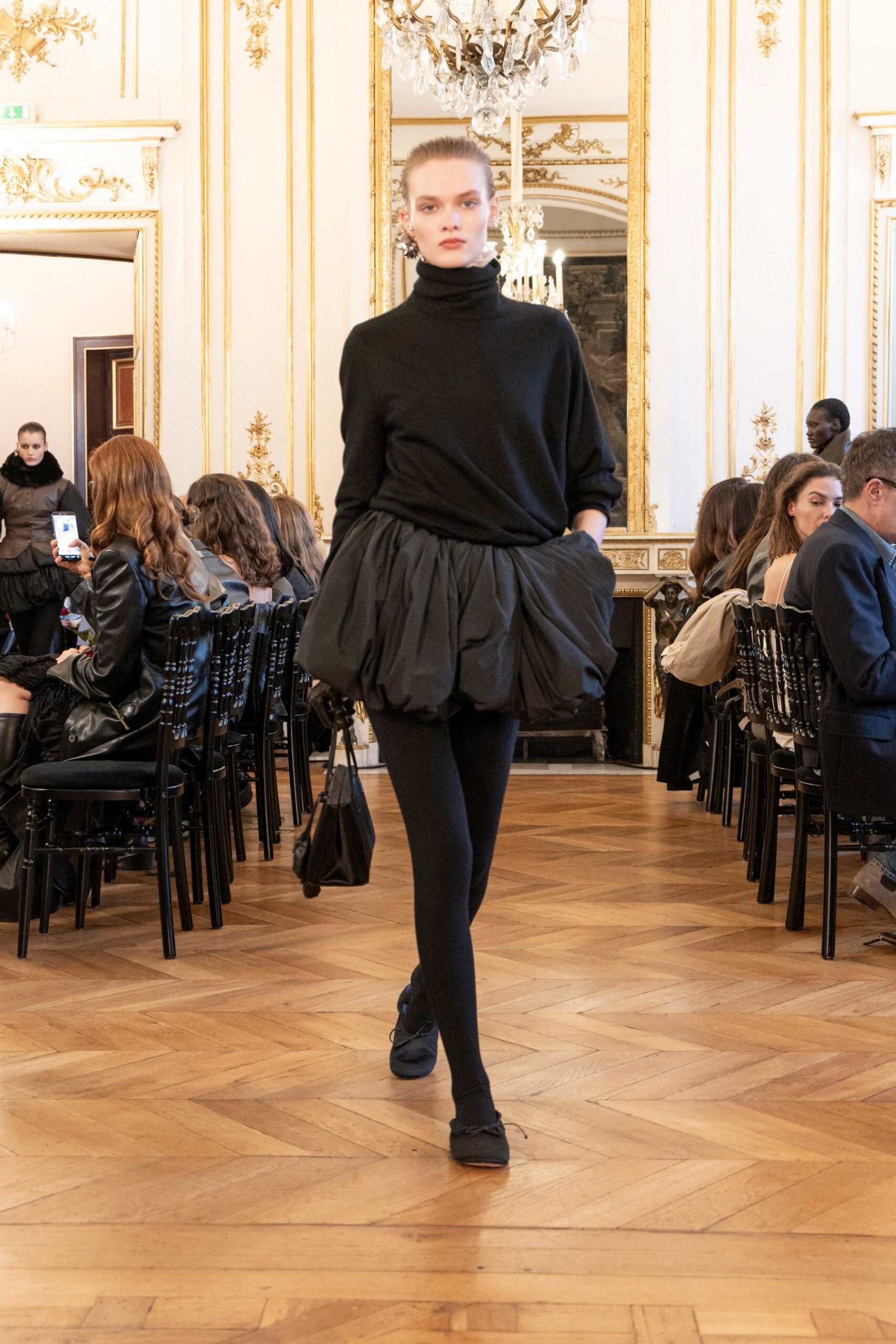 black wool turtleneck top with pleated skirt