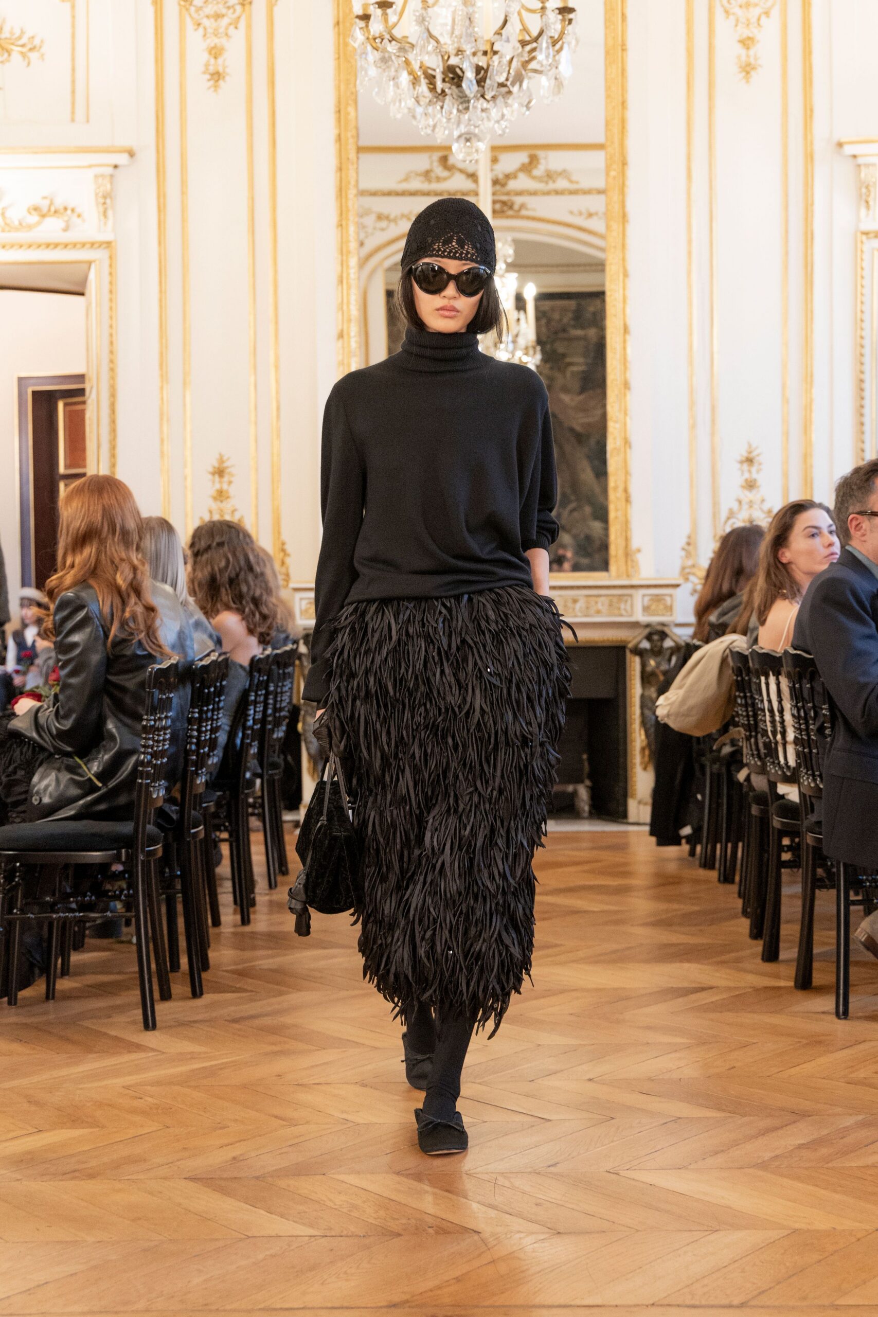 black wool turtleneck top and fringed skirt