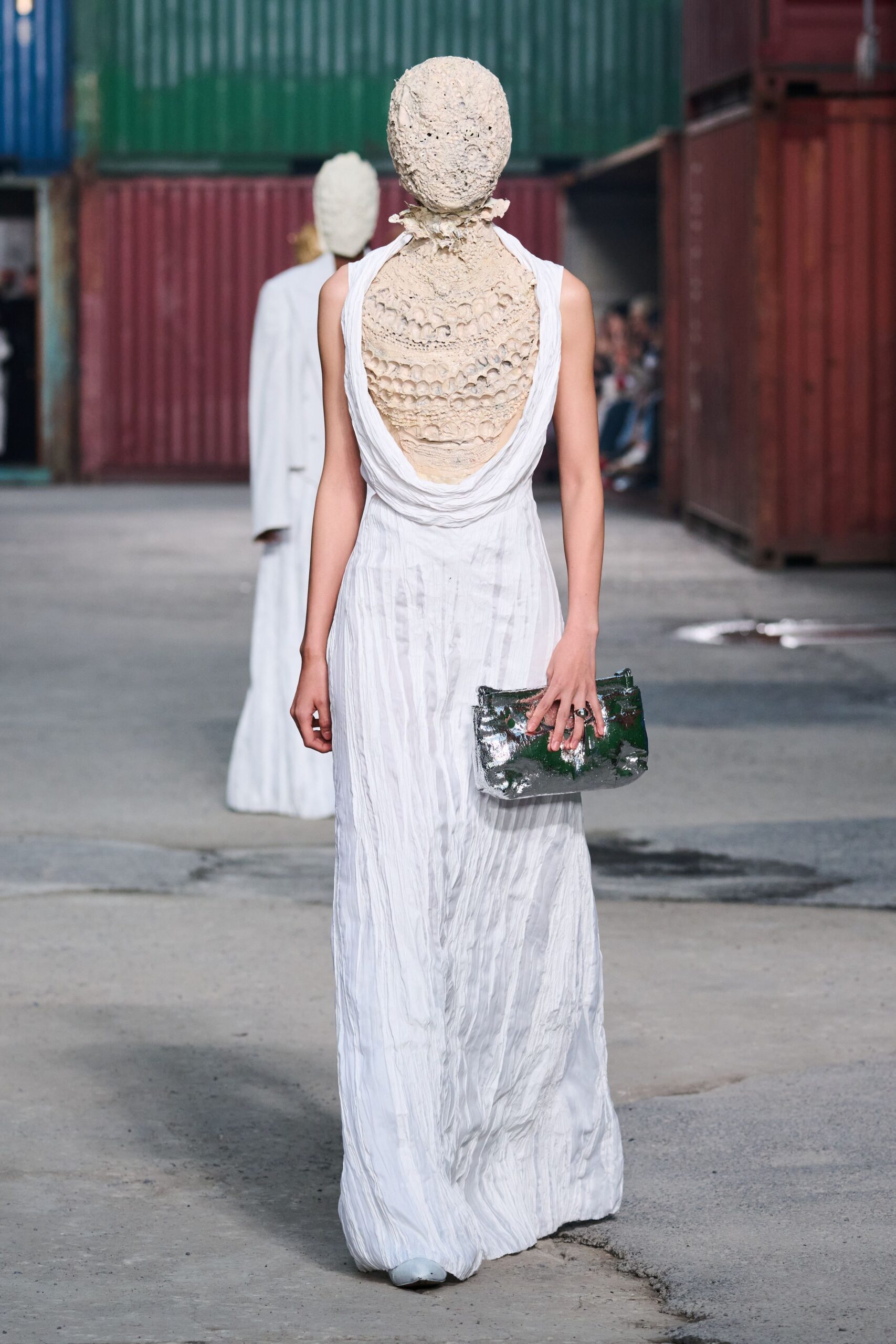 white cotton sleeveless backless fitted draped flowing gown