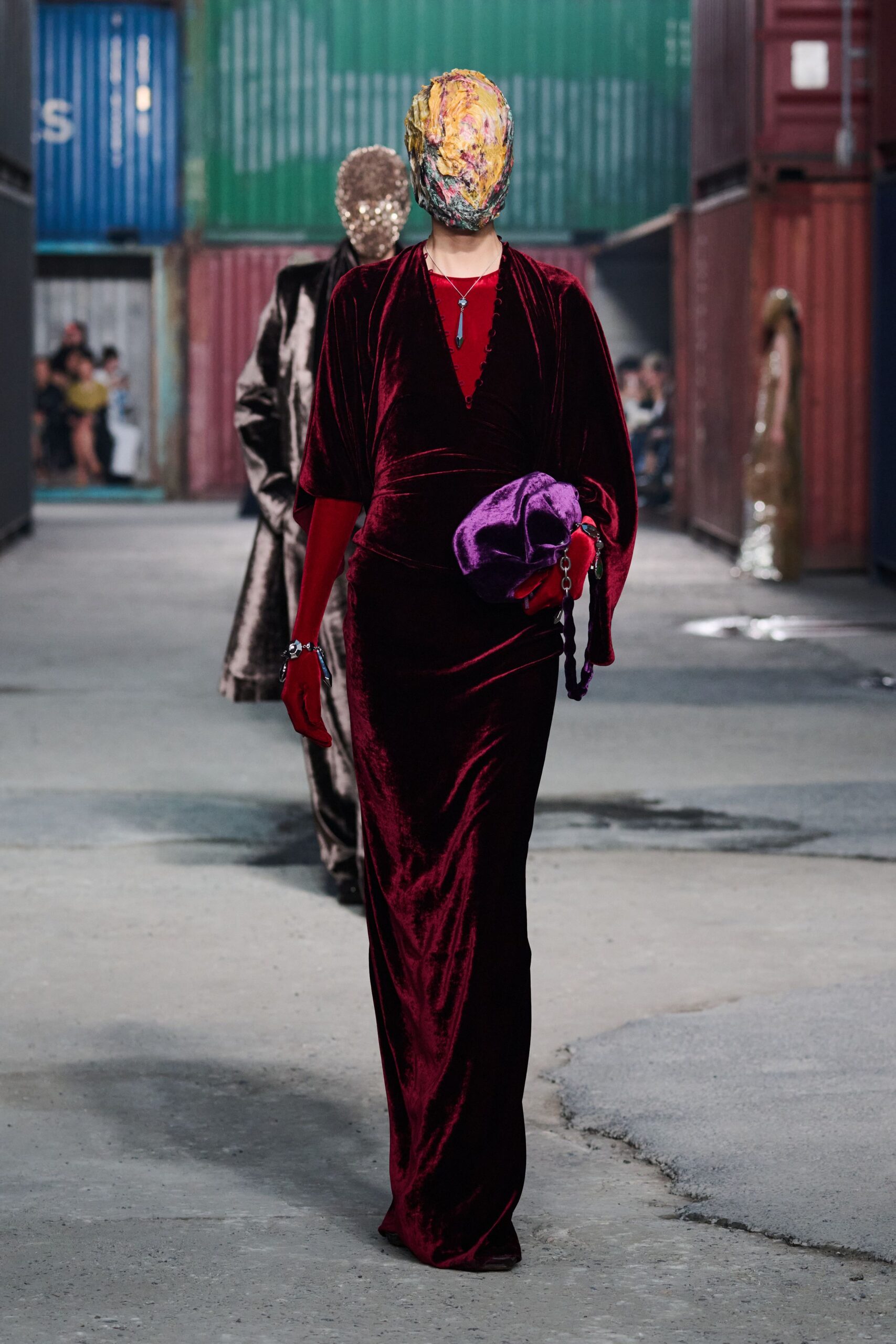 red velvet fitted gown with purple bag