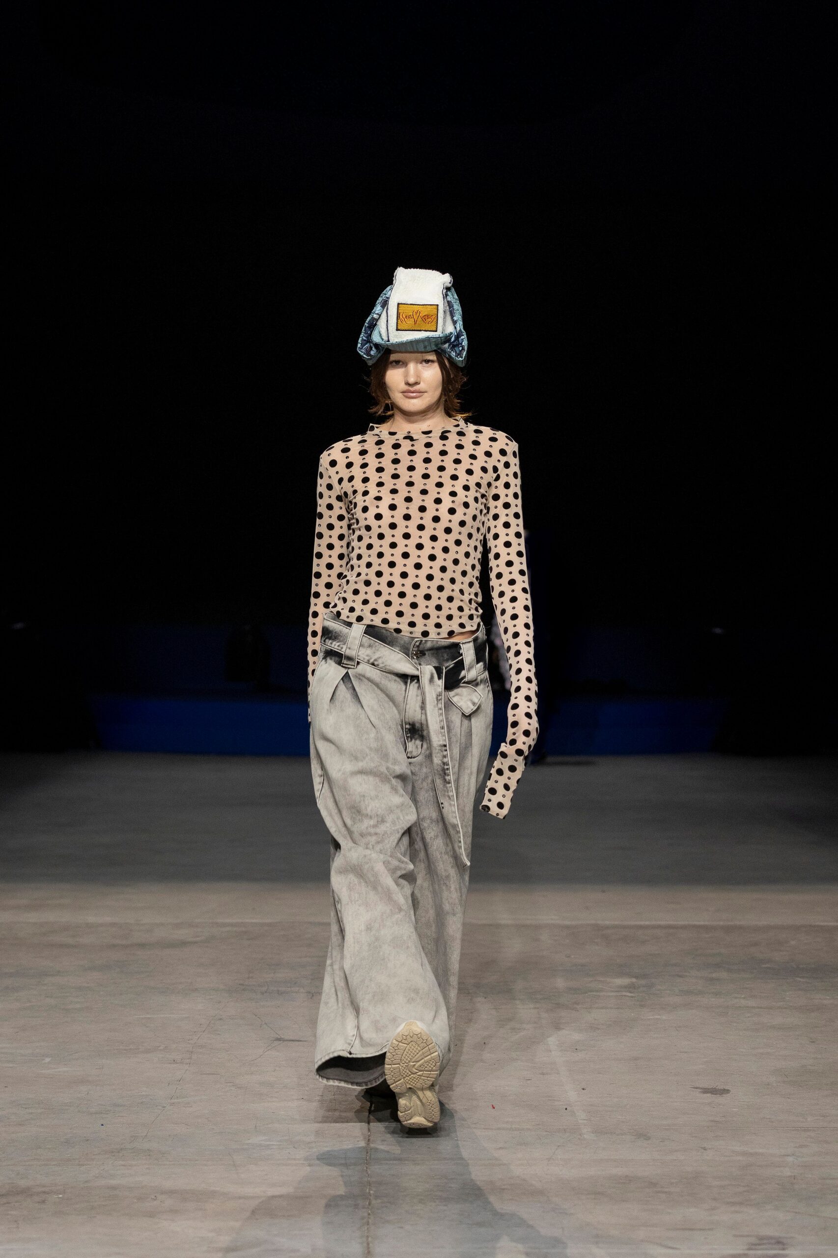 beige polka-dot top with gray pants
