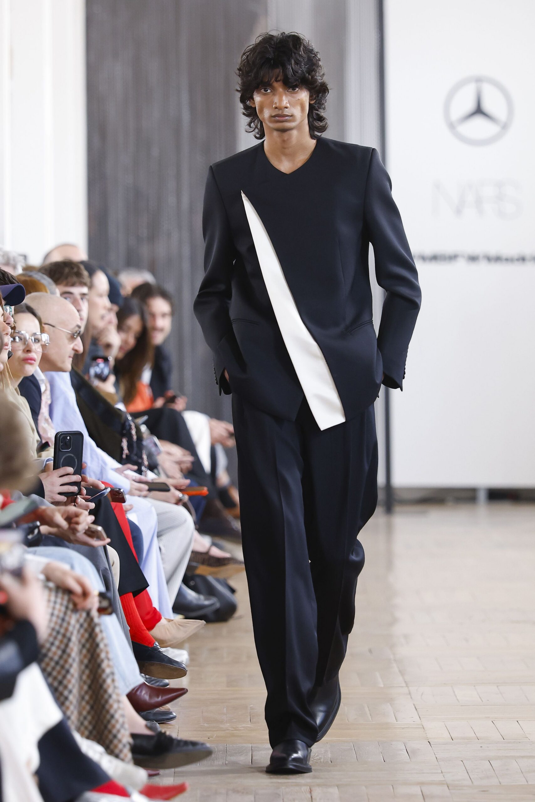 black fitted suit with asymmetric detail