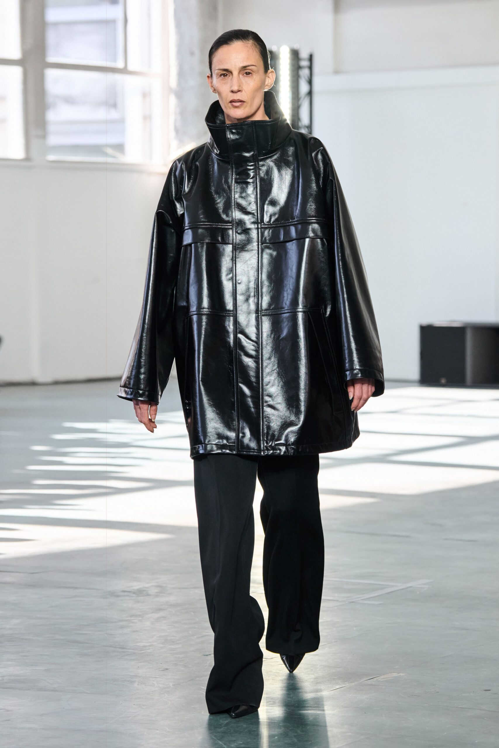 black leather long-sleeve collared oversized shiny coat