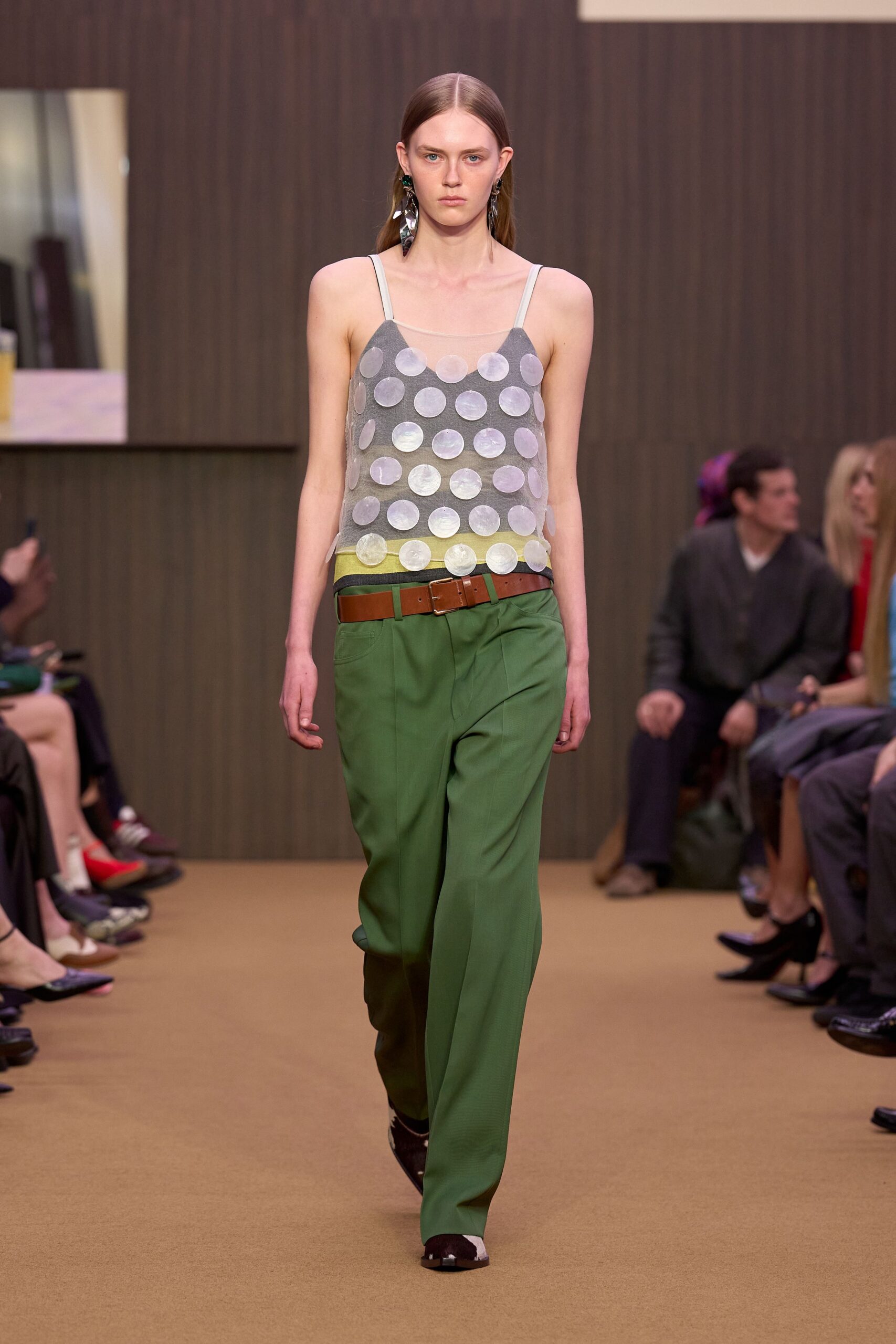 gray polka-dot top with green pants