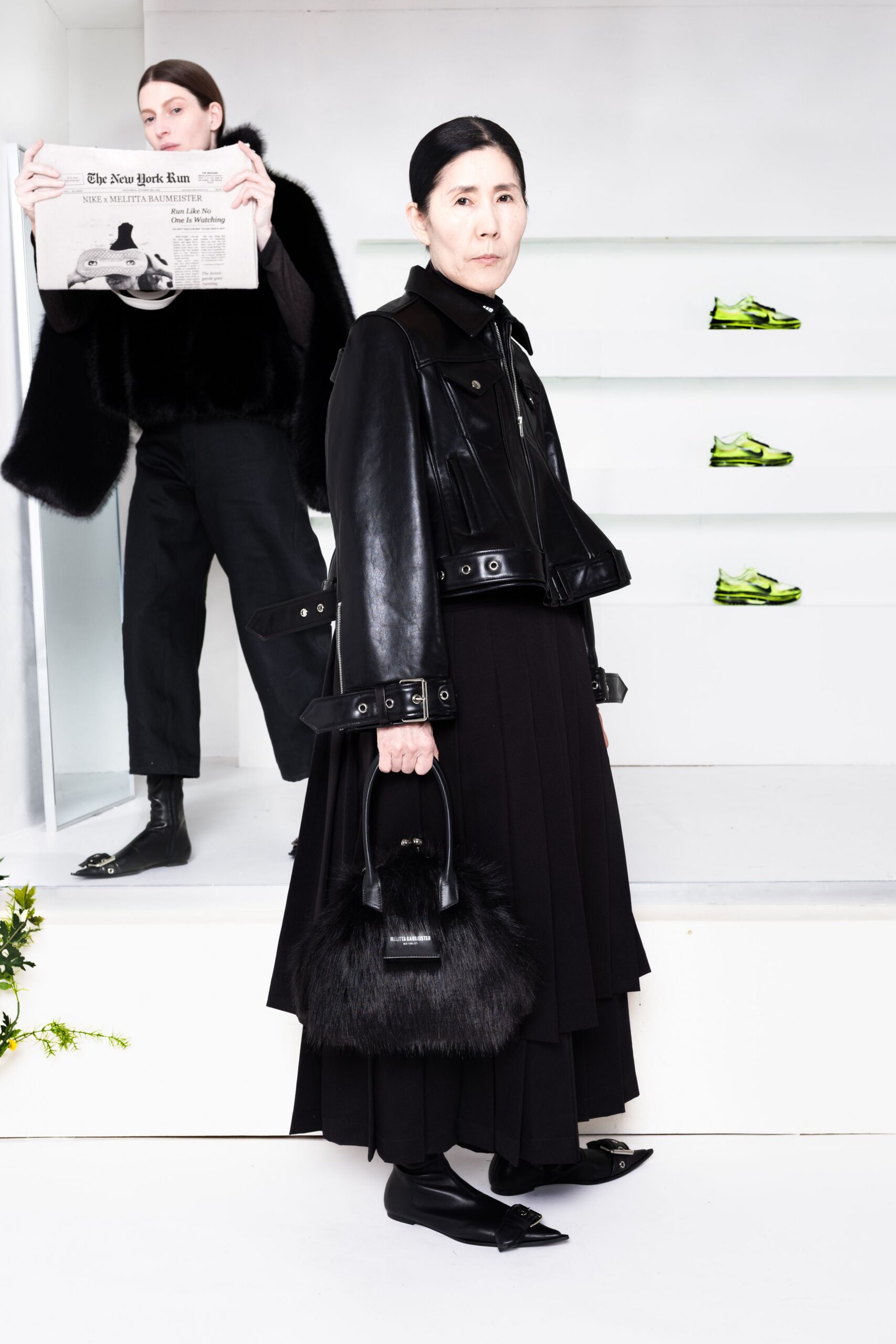black leather coat and pleated skirt