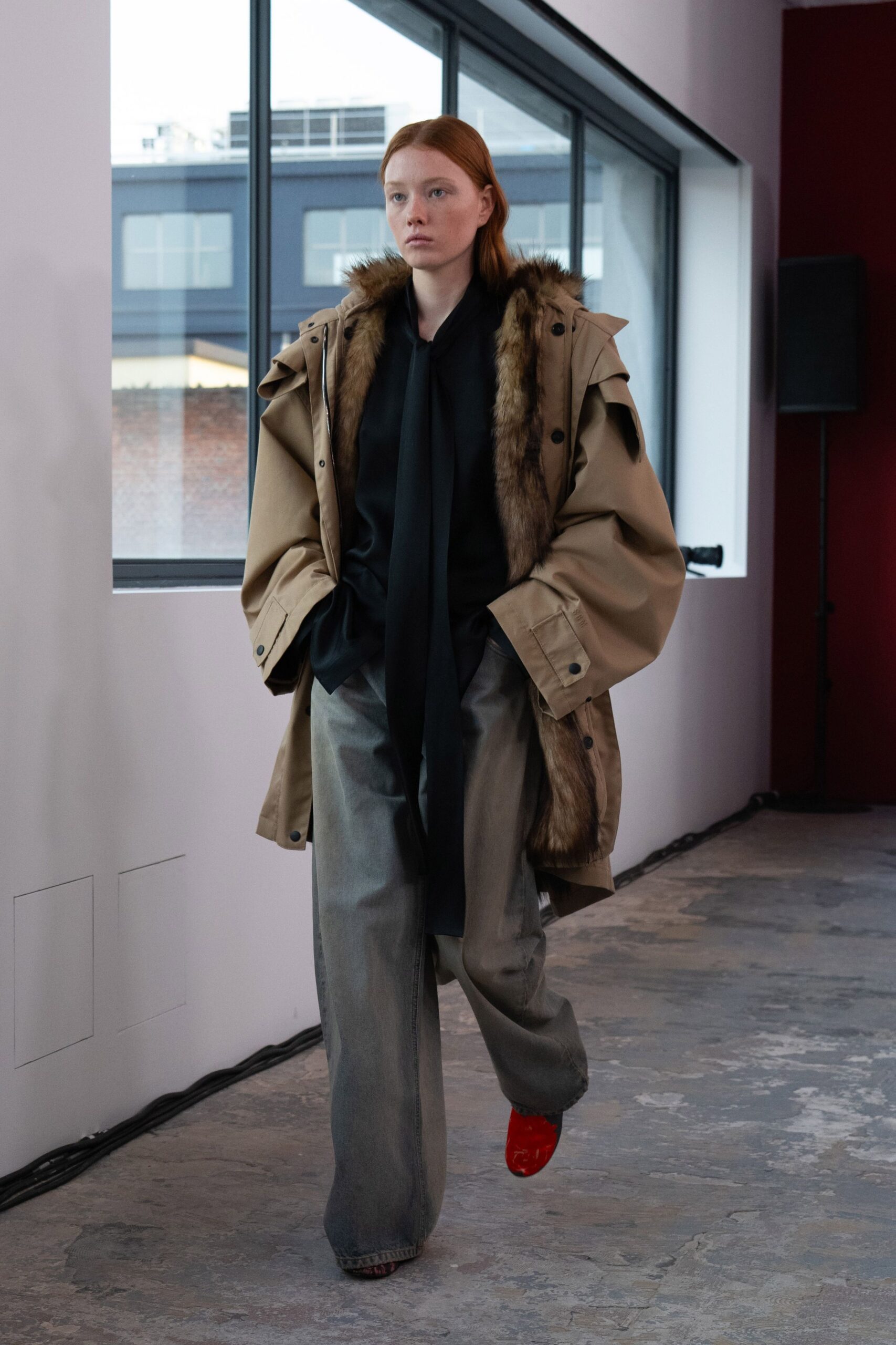 beige parka black top gray pants red shoes