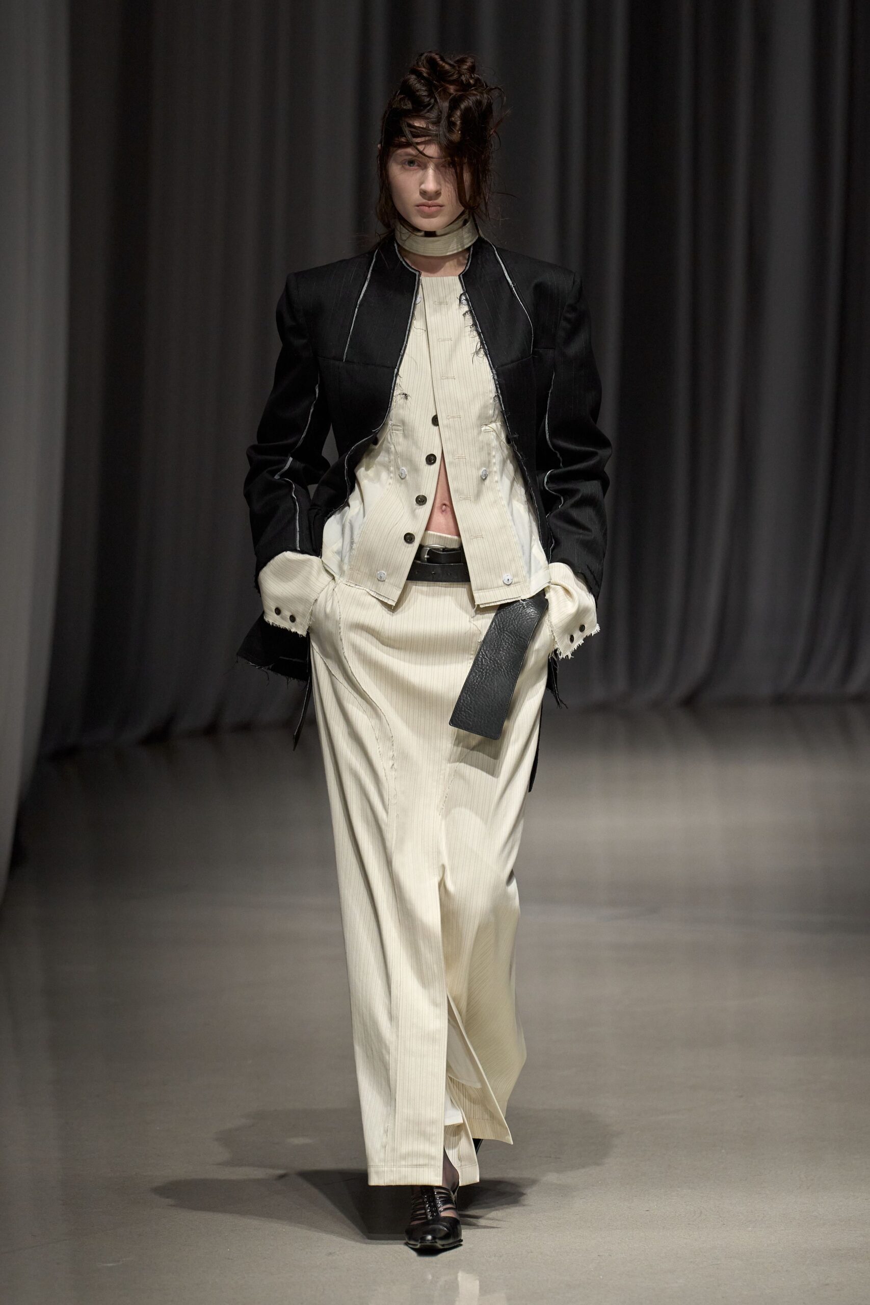 black jacket white shirt beige pants