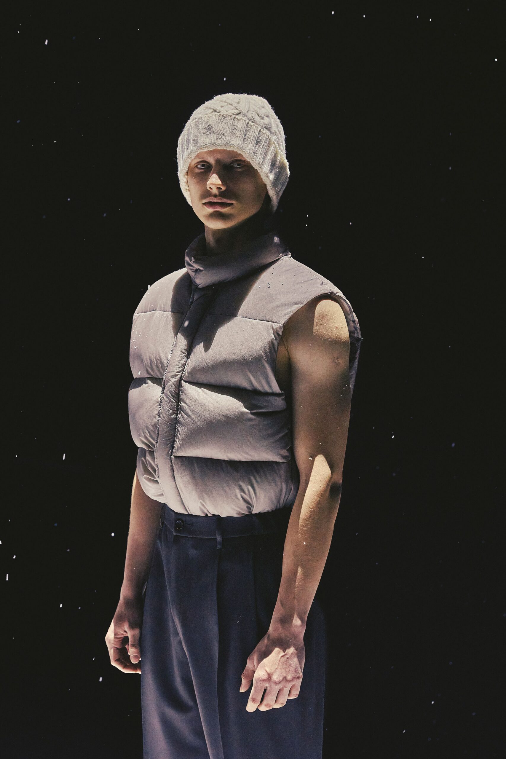 gray puffer vest with black pants