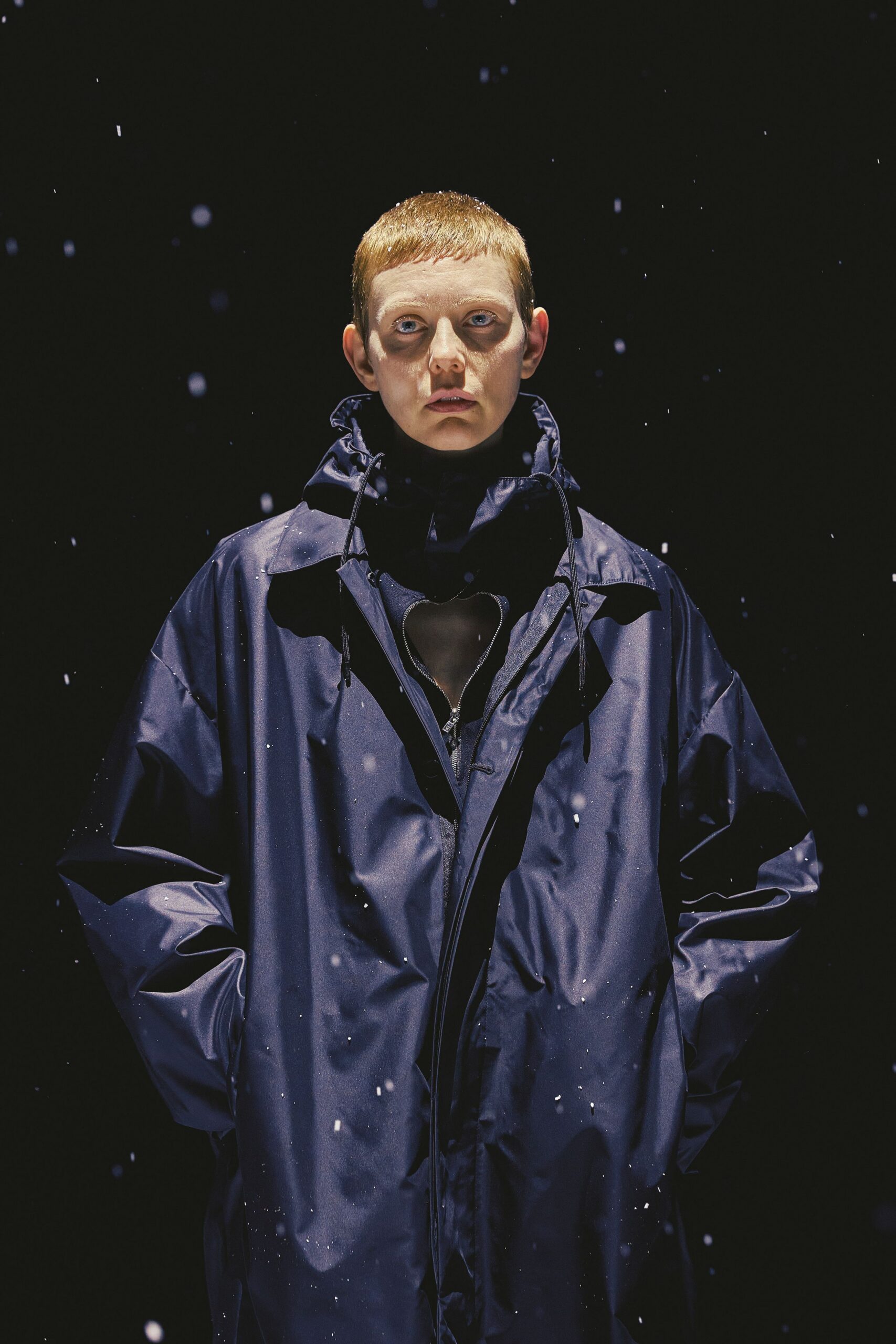 blue vinyl hooded coat with black top