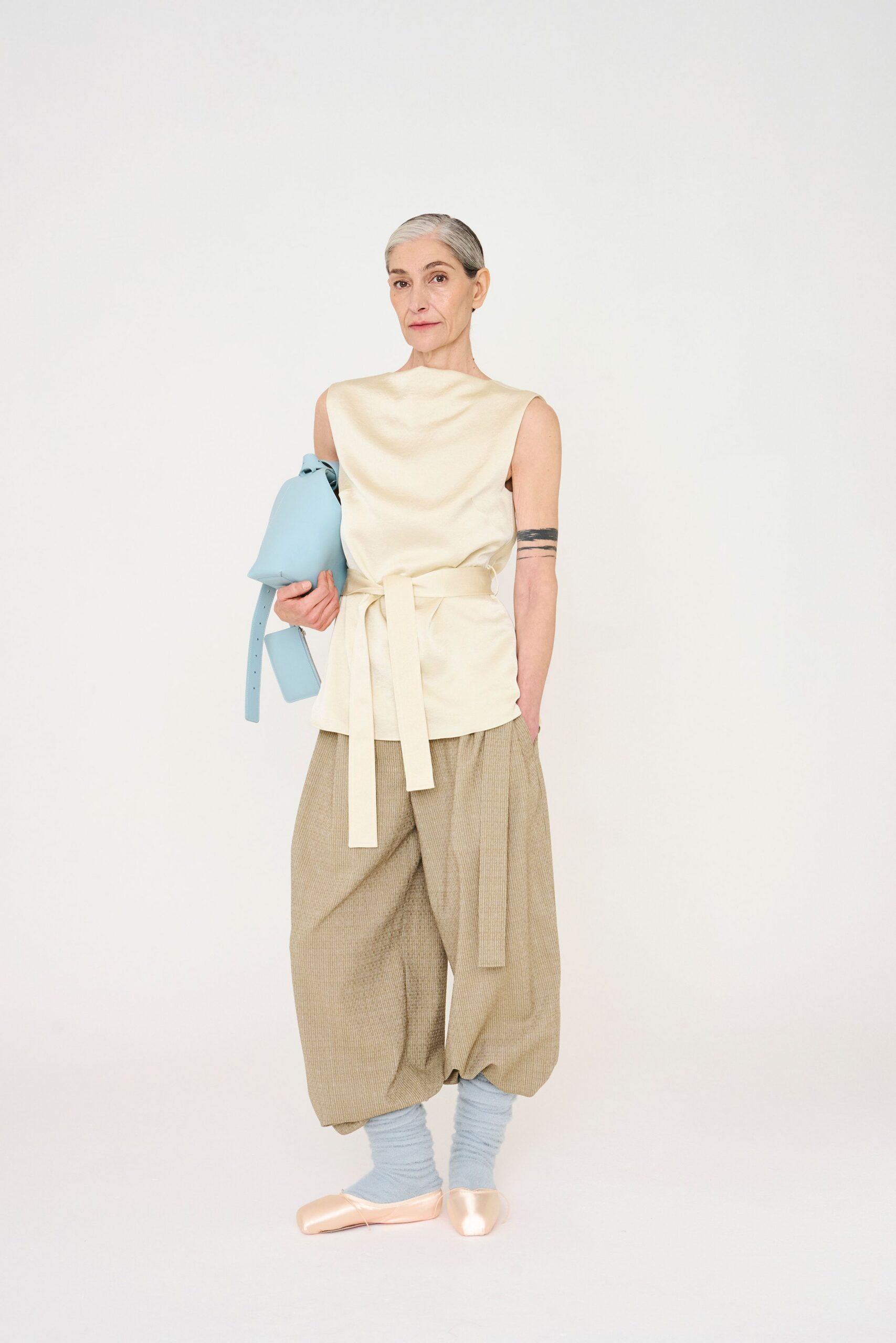 beige silk sleeveless top with relaxed pants