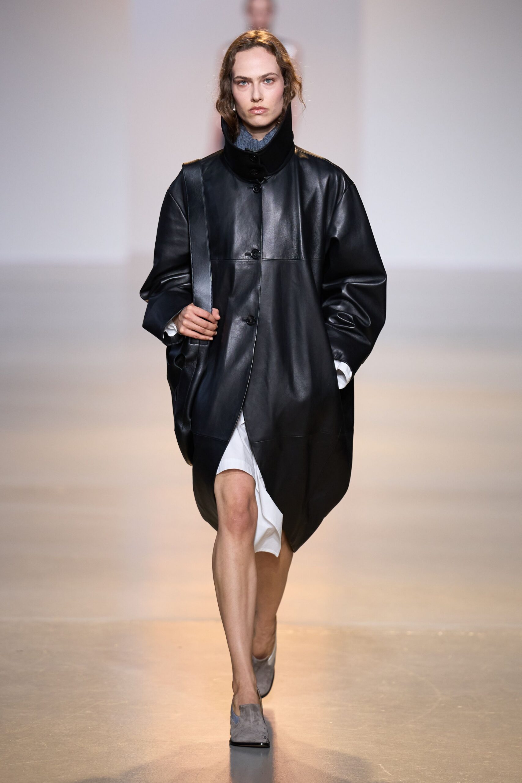 black leather long-sleeve collared oversized buttoned coat
