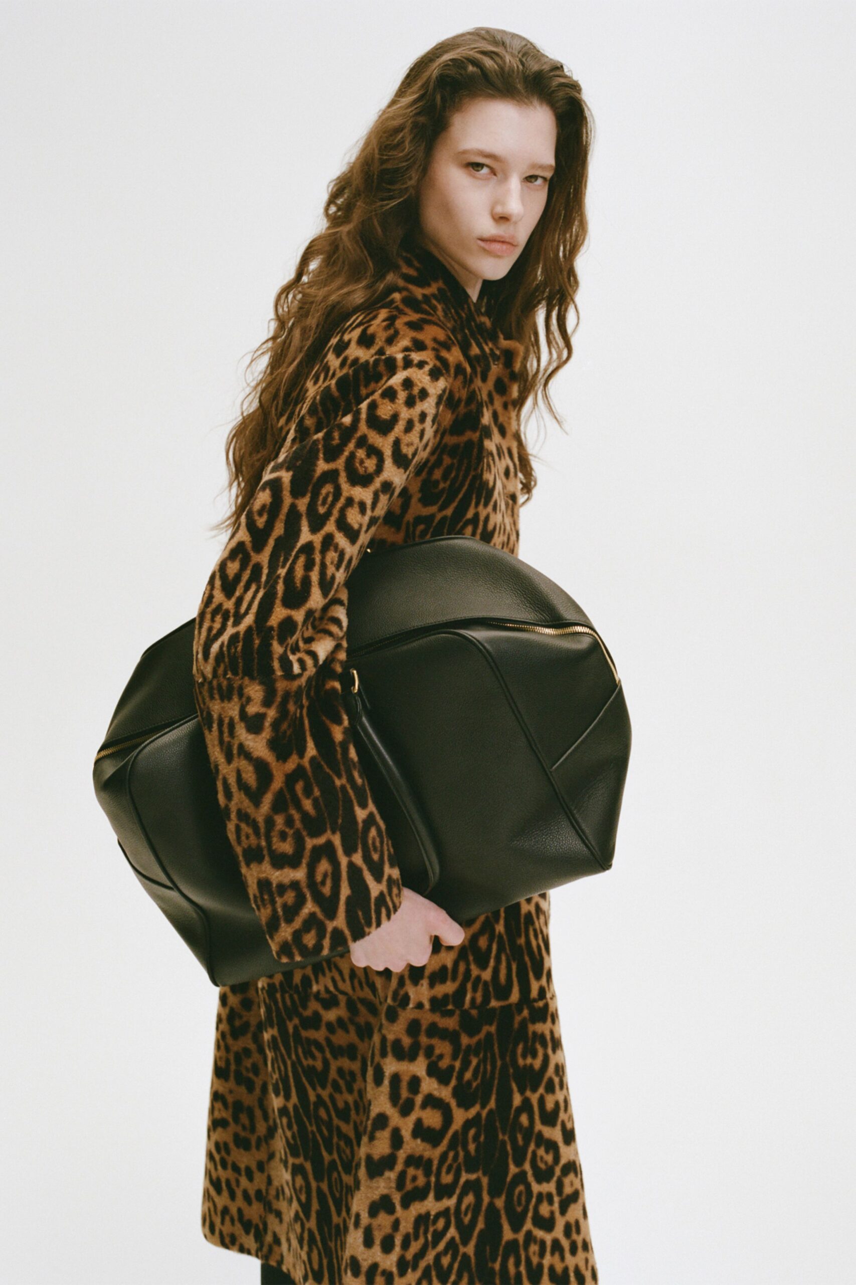 brown animal-print faux-fur coat with black leather bag