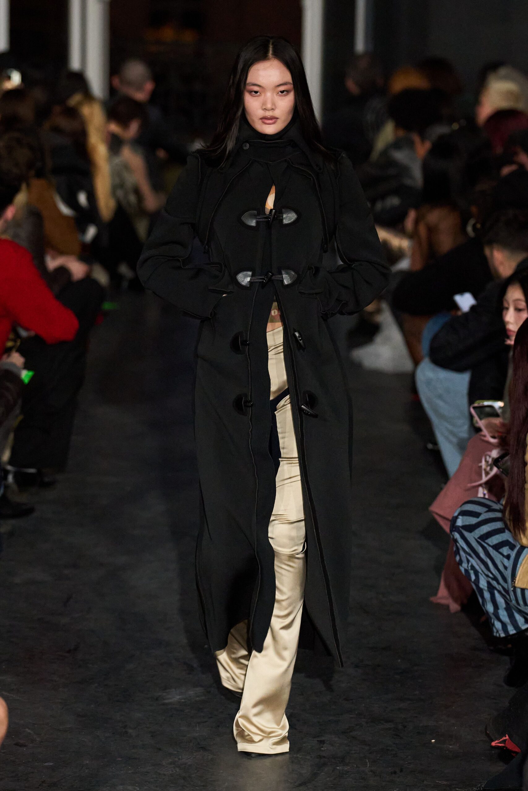 black wool coat and beige pants