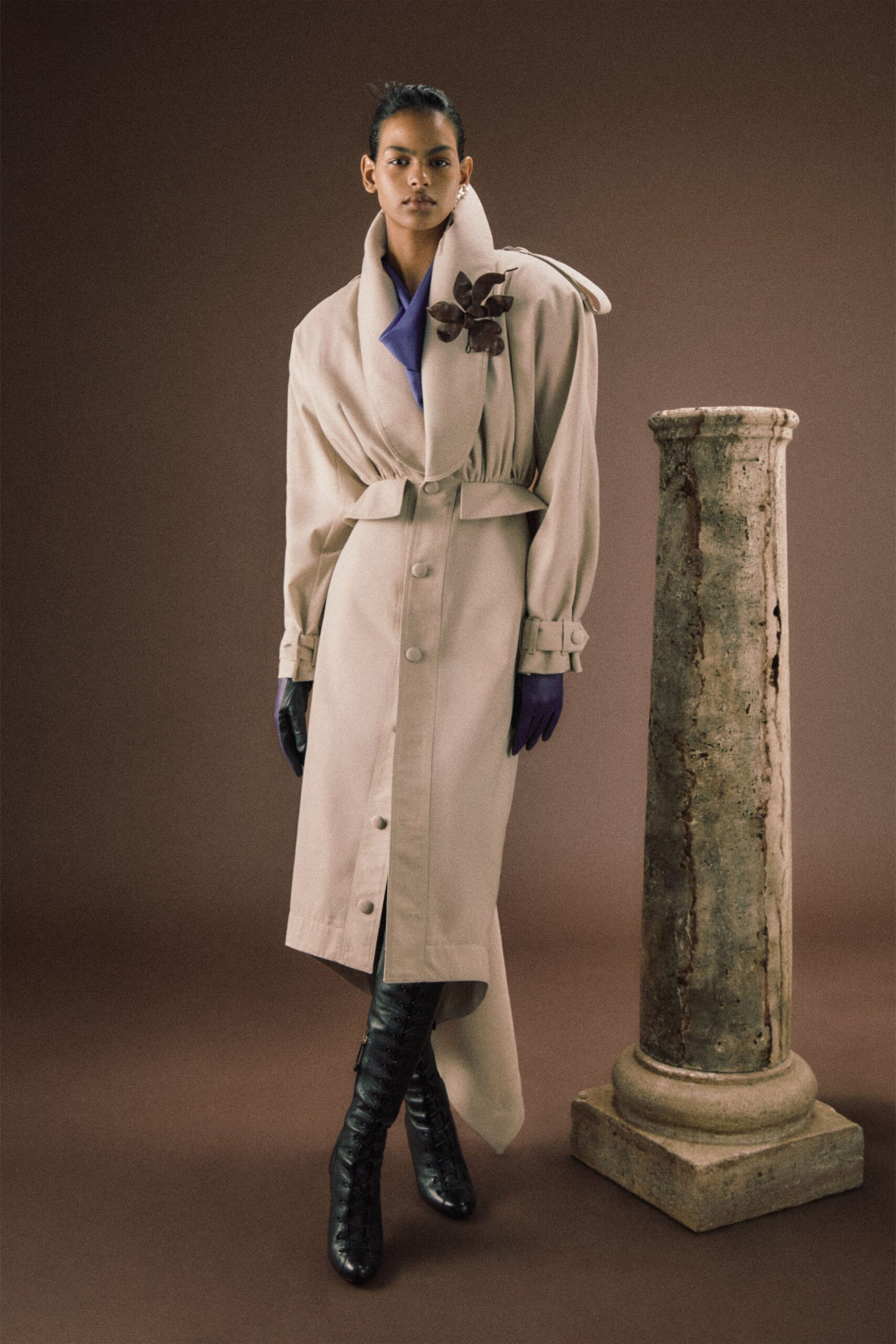 beige relaxed coat with purple gloves