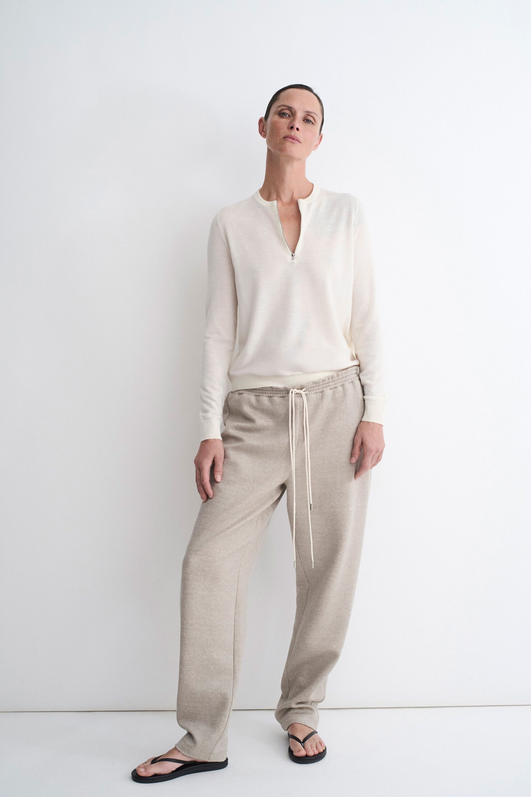 white relaxed top beige pants sandals