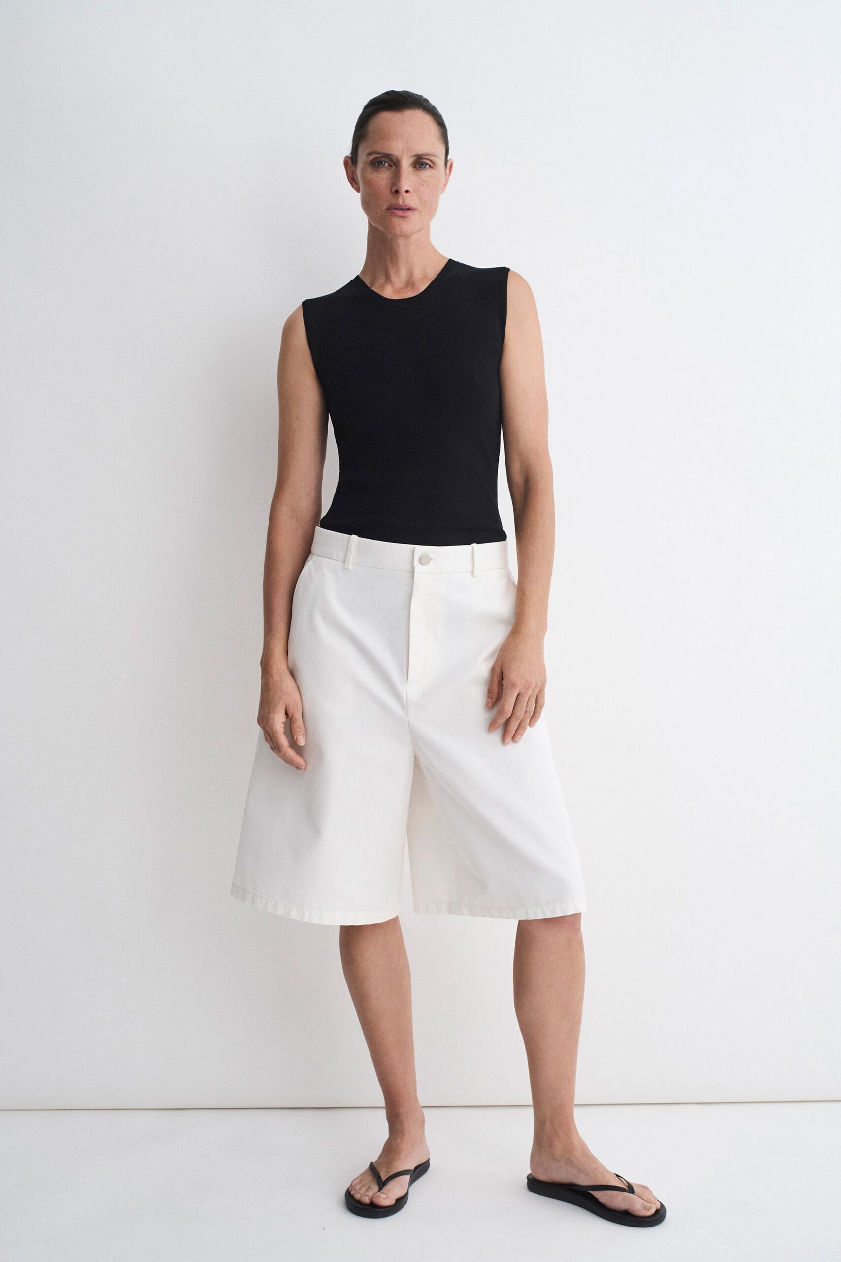 black tank-top white shorts sandals