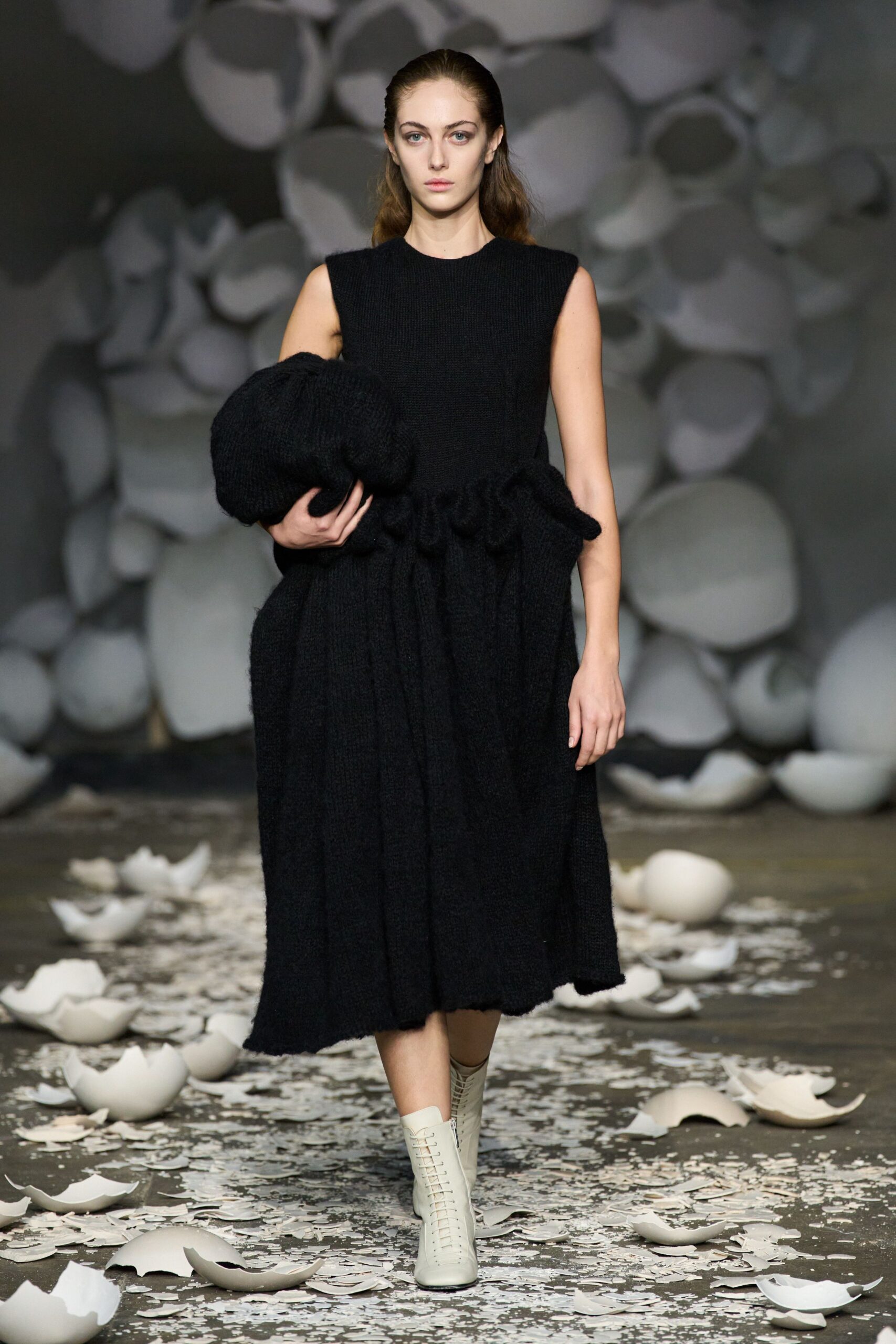black wool sleeveless midi dress with white shoes