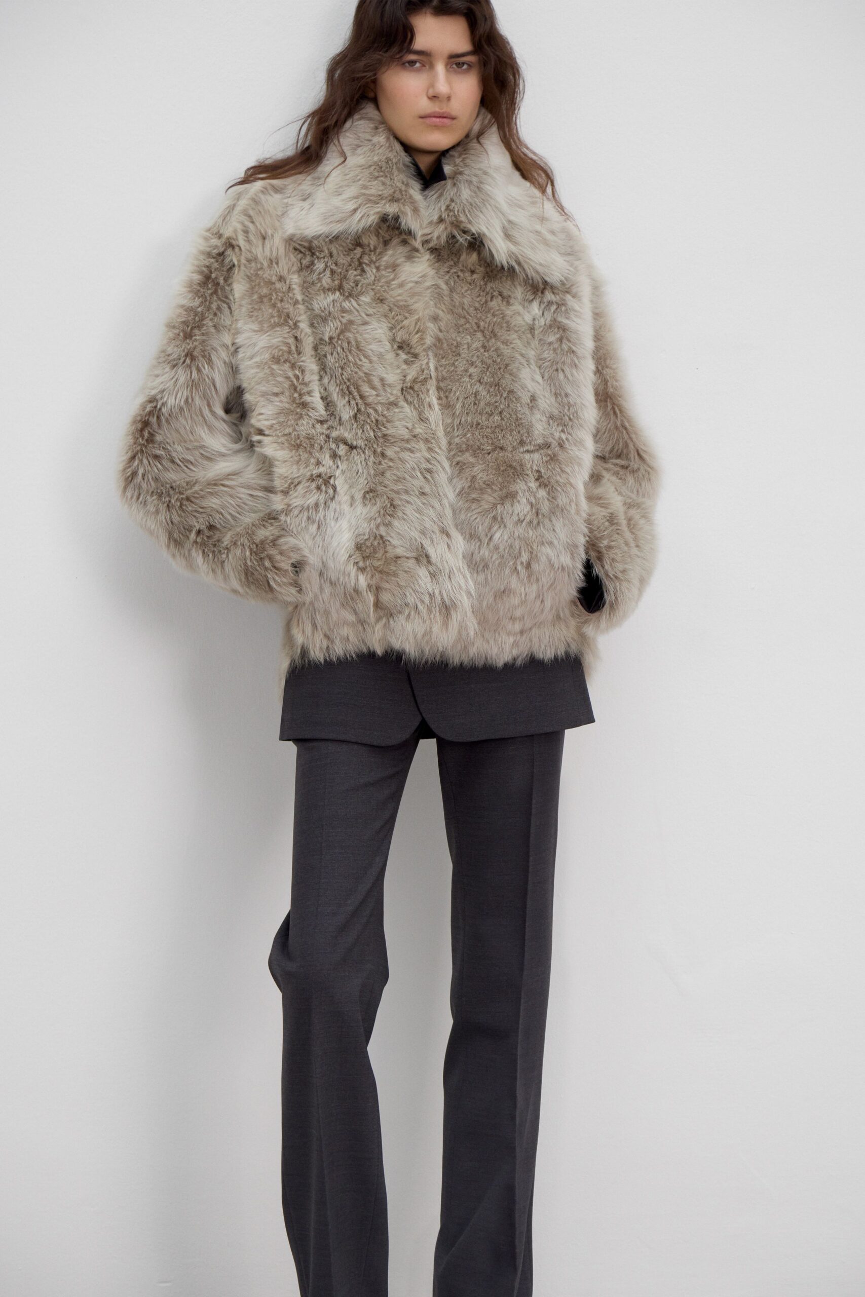 gray faux-fur coat and black tailored pants
