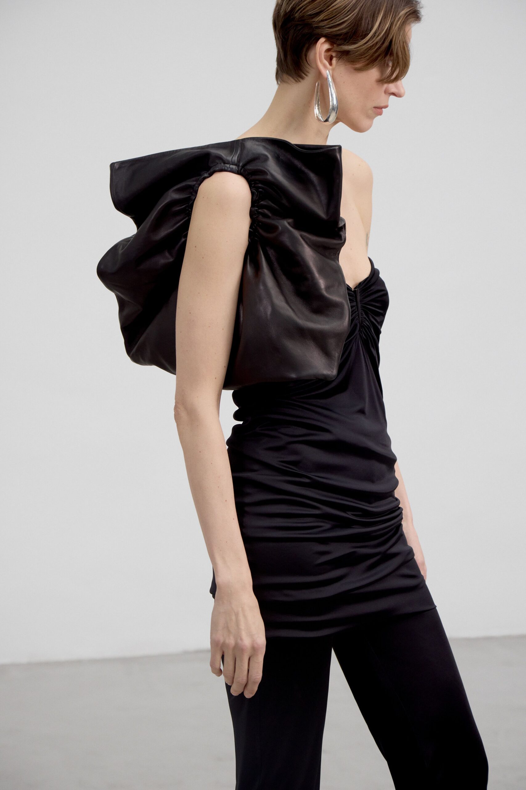 black leather sleeveless off-shoulder fitted ruched mini dress