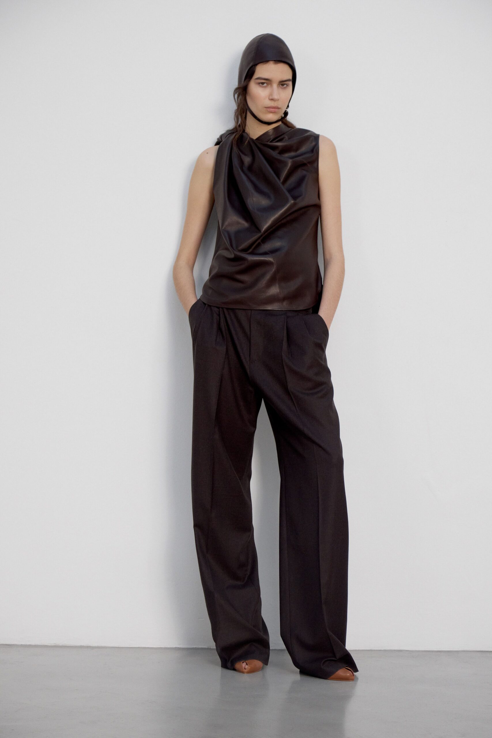 black leather sleeveless high-neck fitted draped top