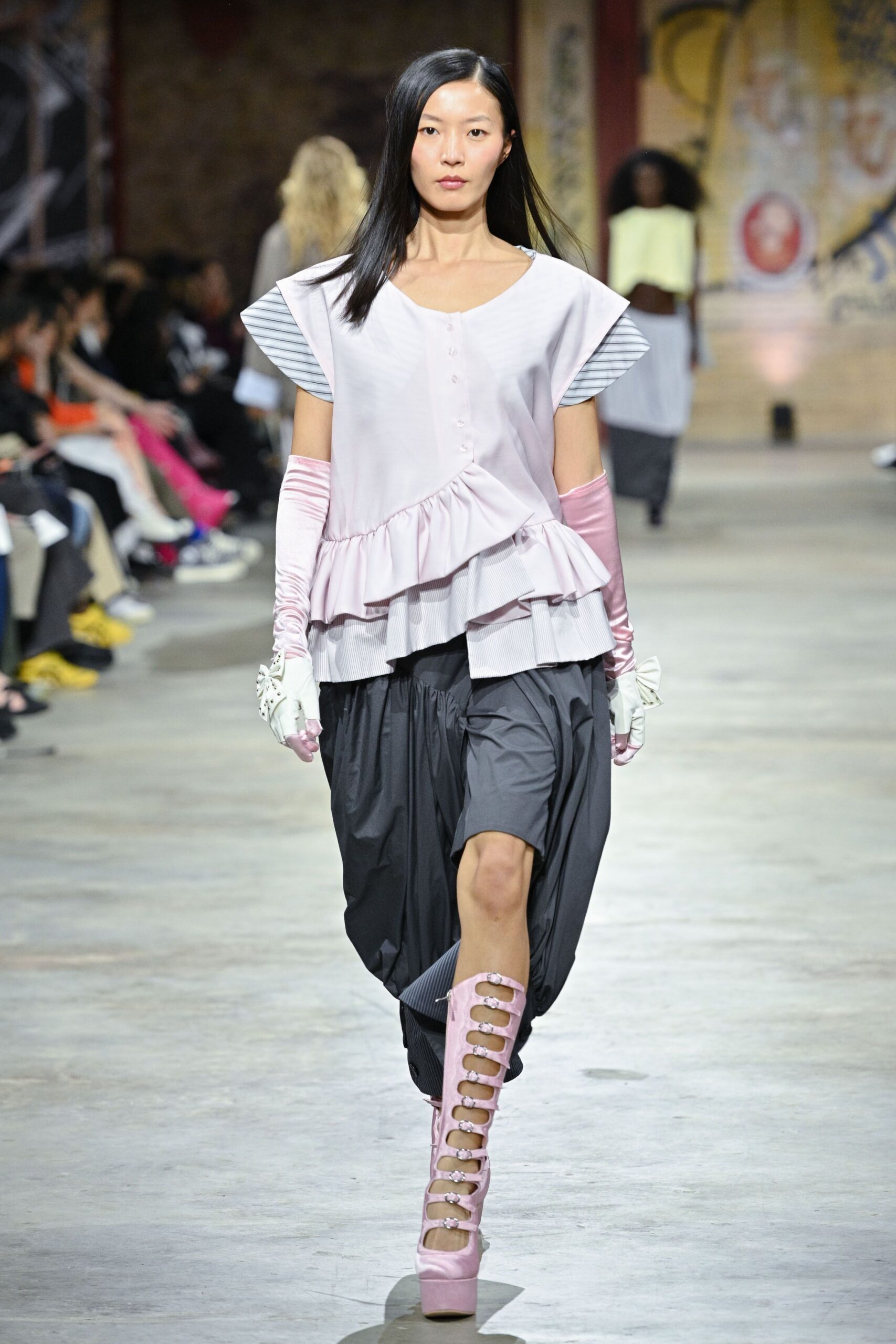 pink layered top with black pants