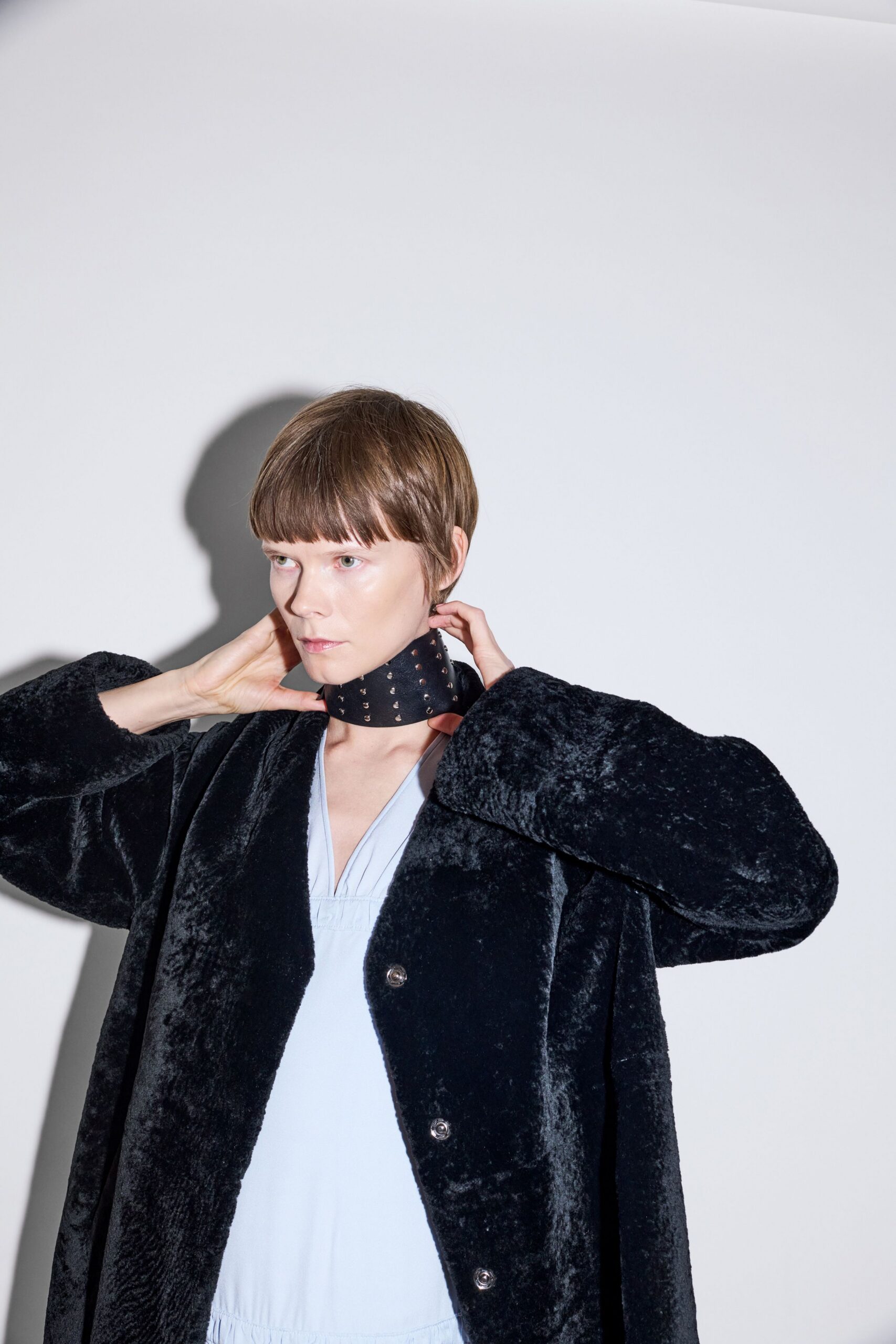 black faux-fur coat with light blue top