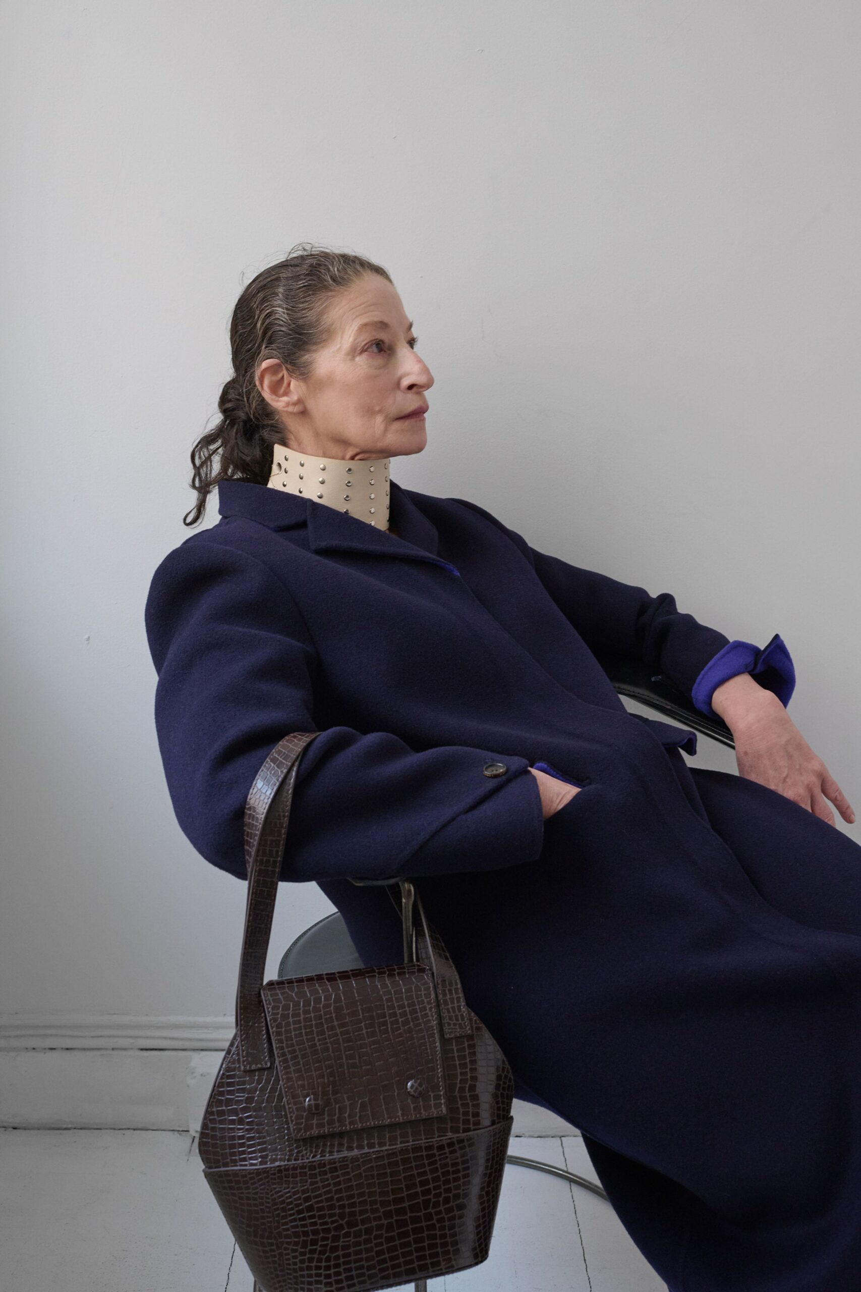 navy wool relaxed coat with brown bag