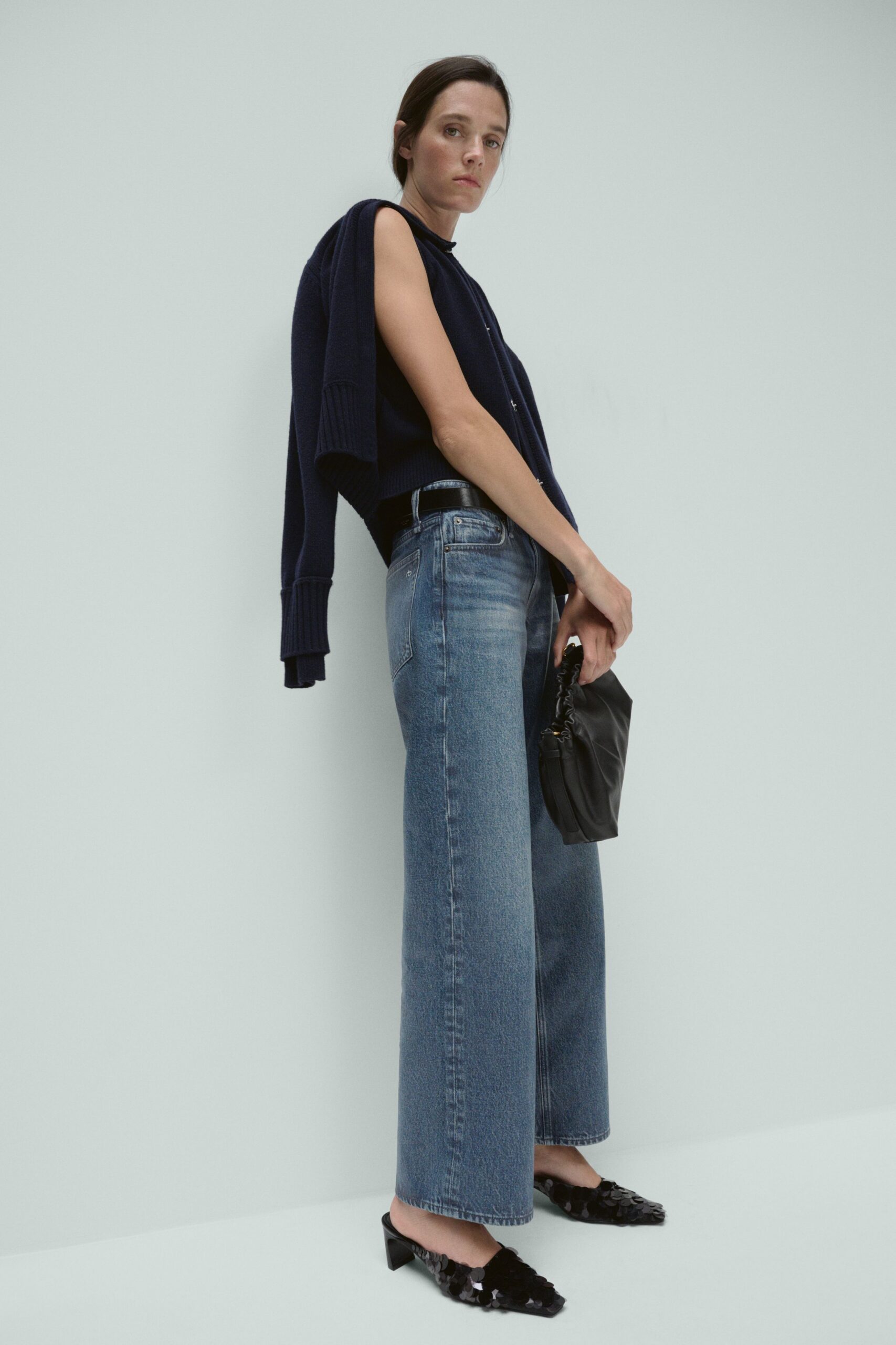 navy sweater with wide-leg jeans
