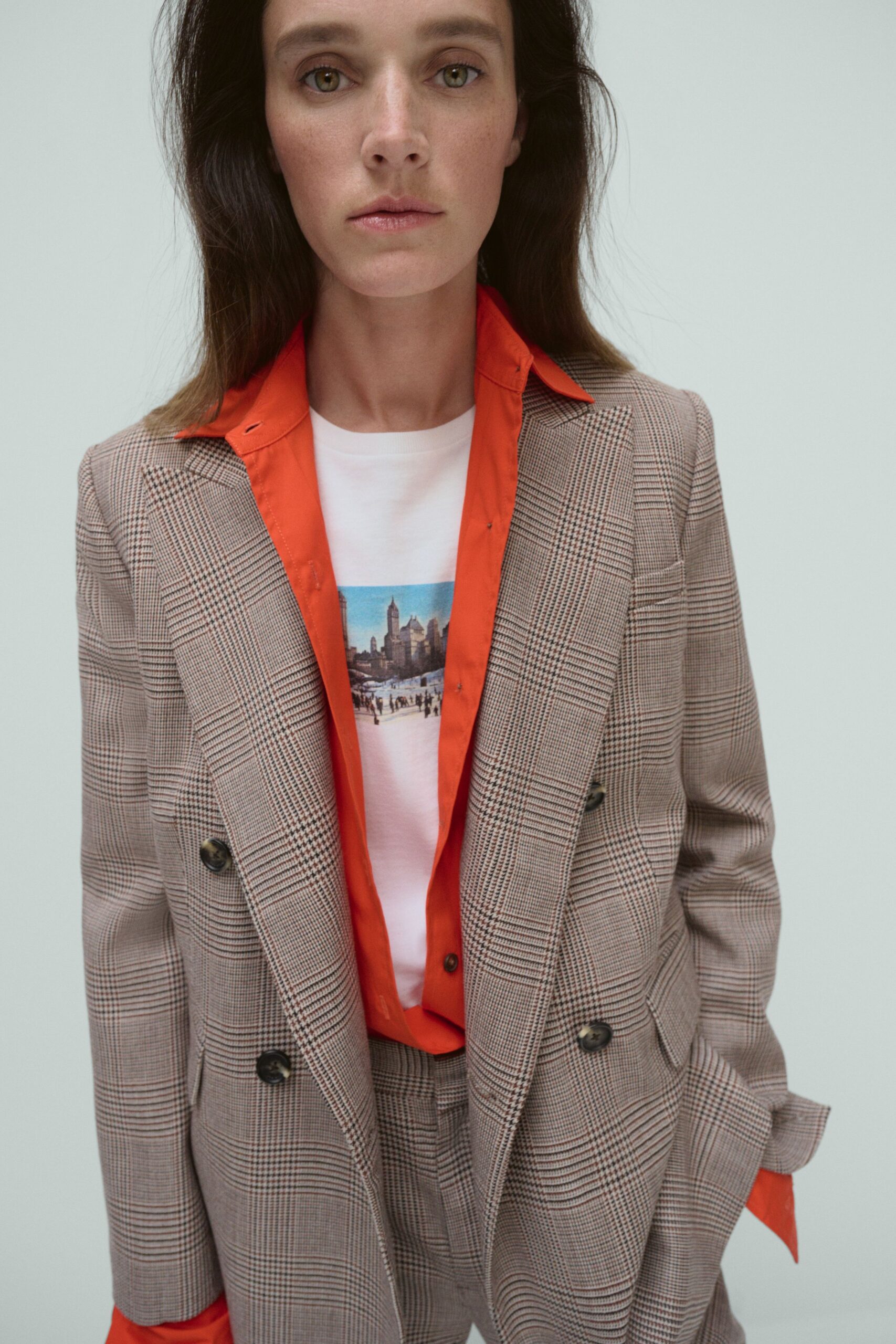 beige tailored blazer with orange shirt