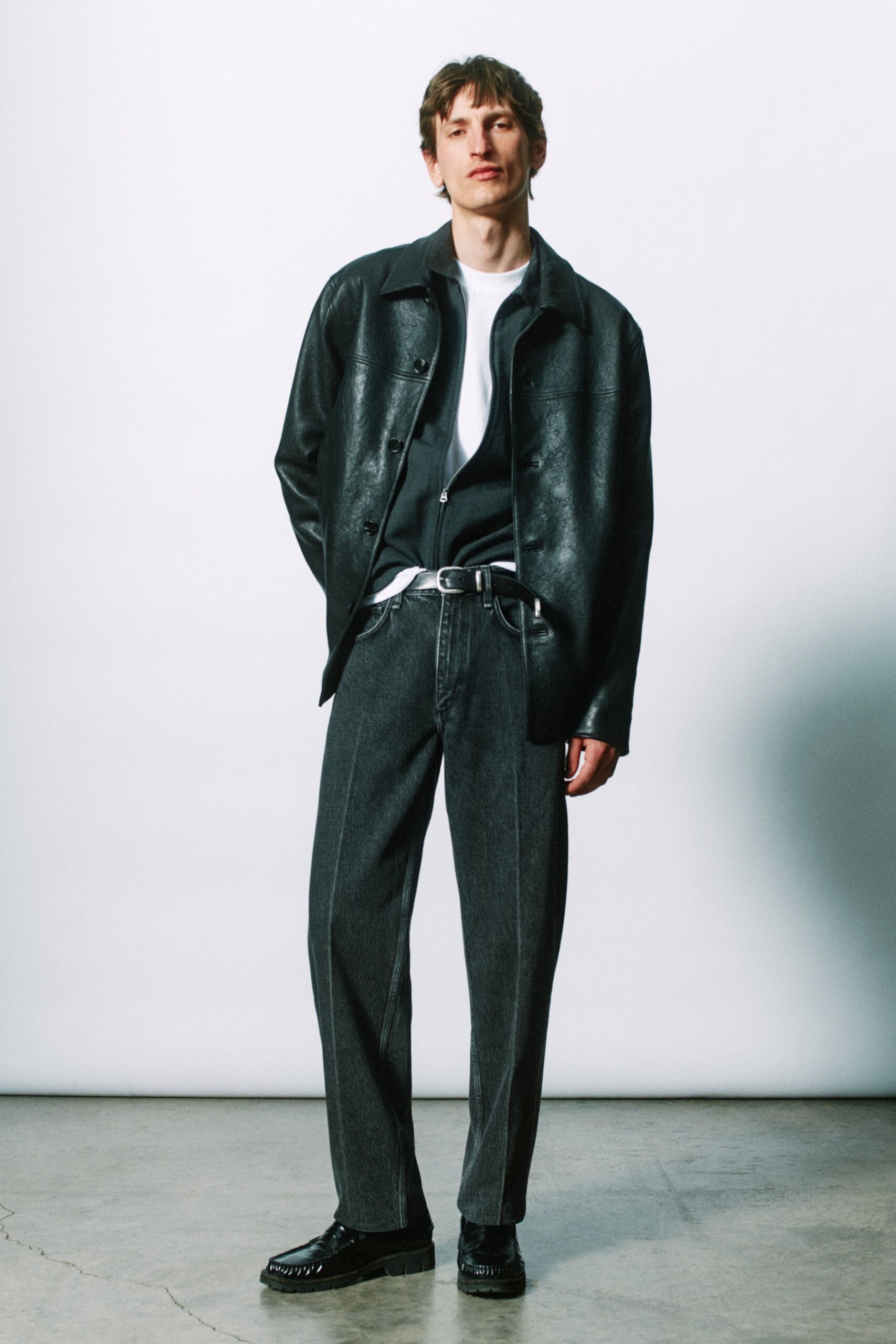 black leather jacket with gray pants