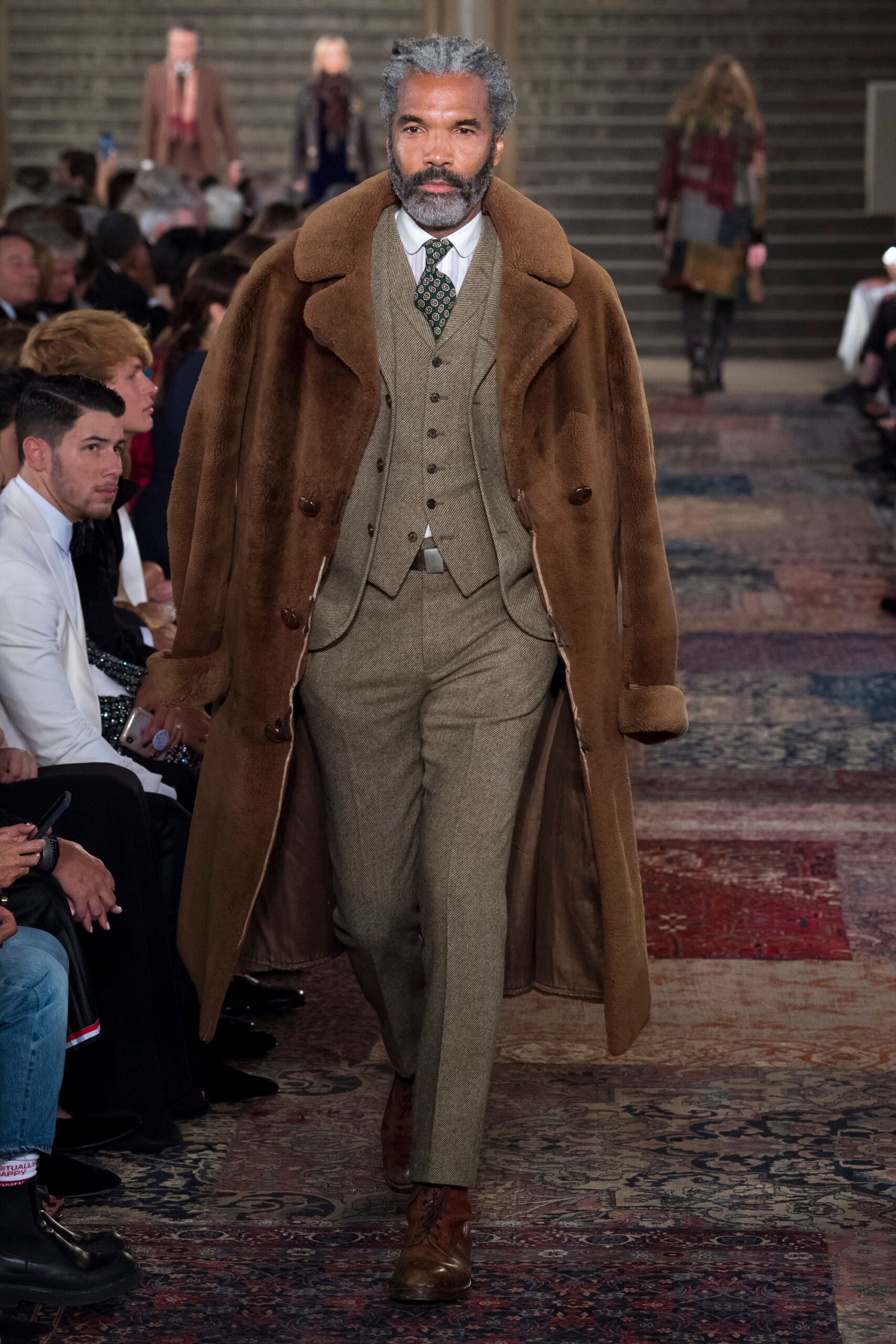 brown fur coat with gray suit