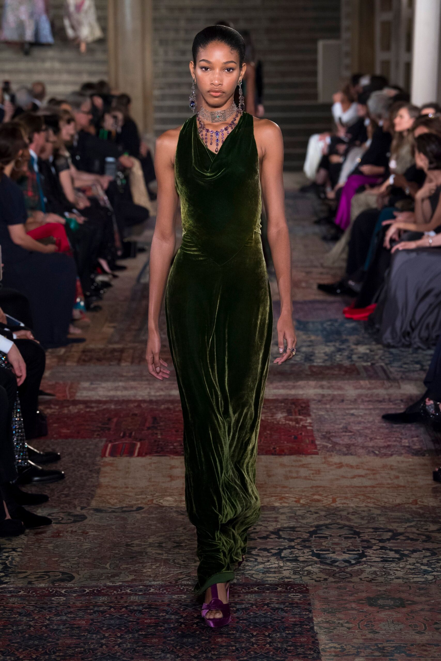 green velvet sleeveless high-neck fitted draped flowing gown