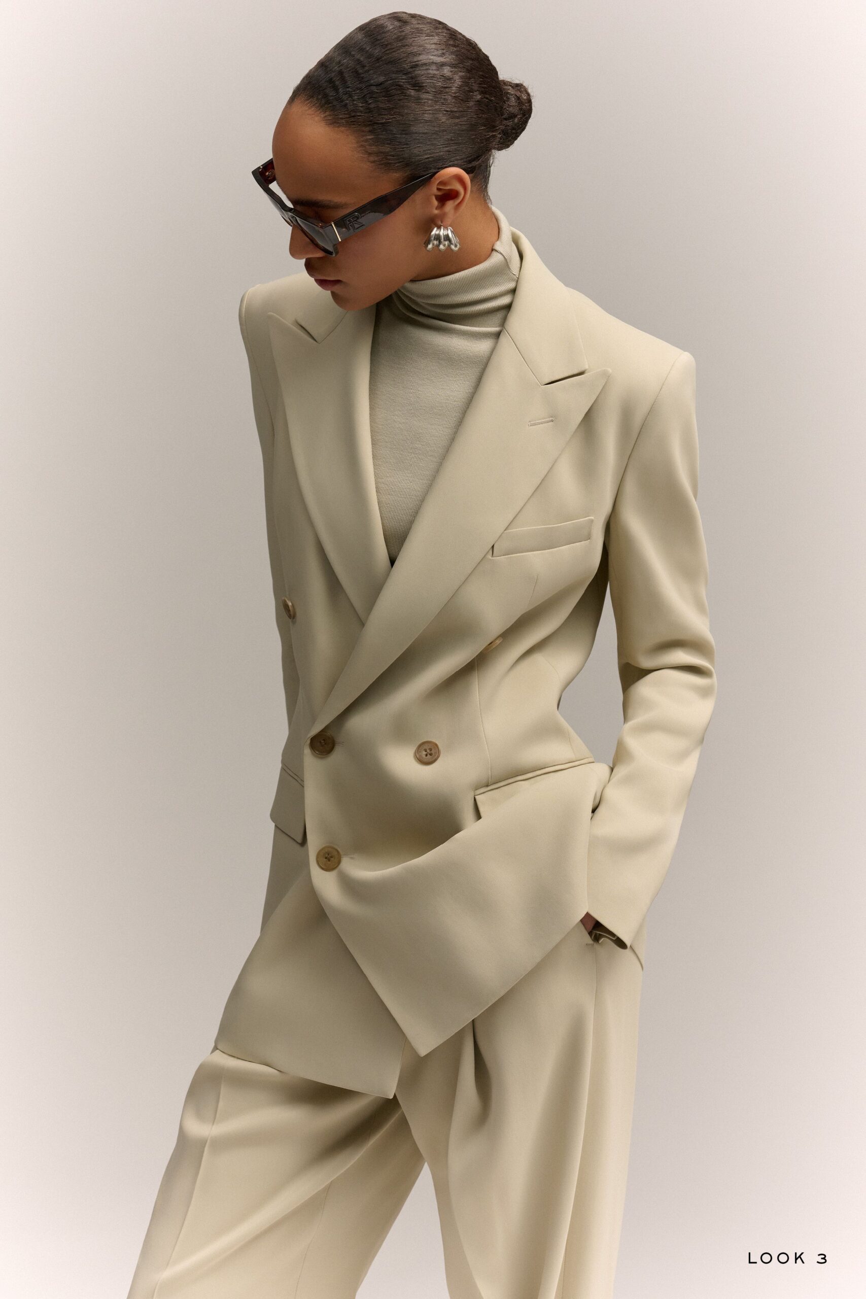 beige tailored blazer with gray turtleneck