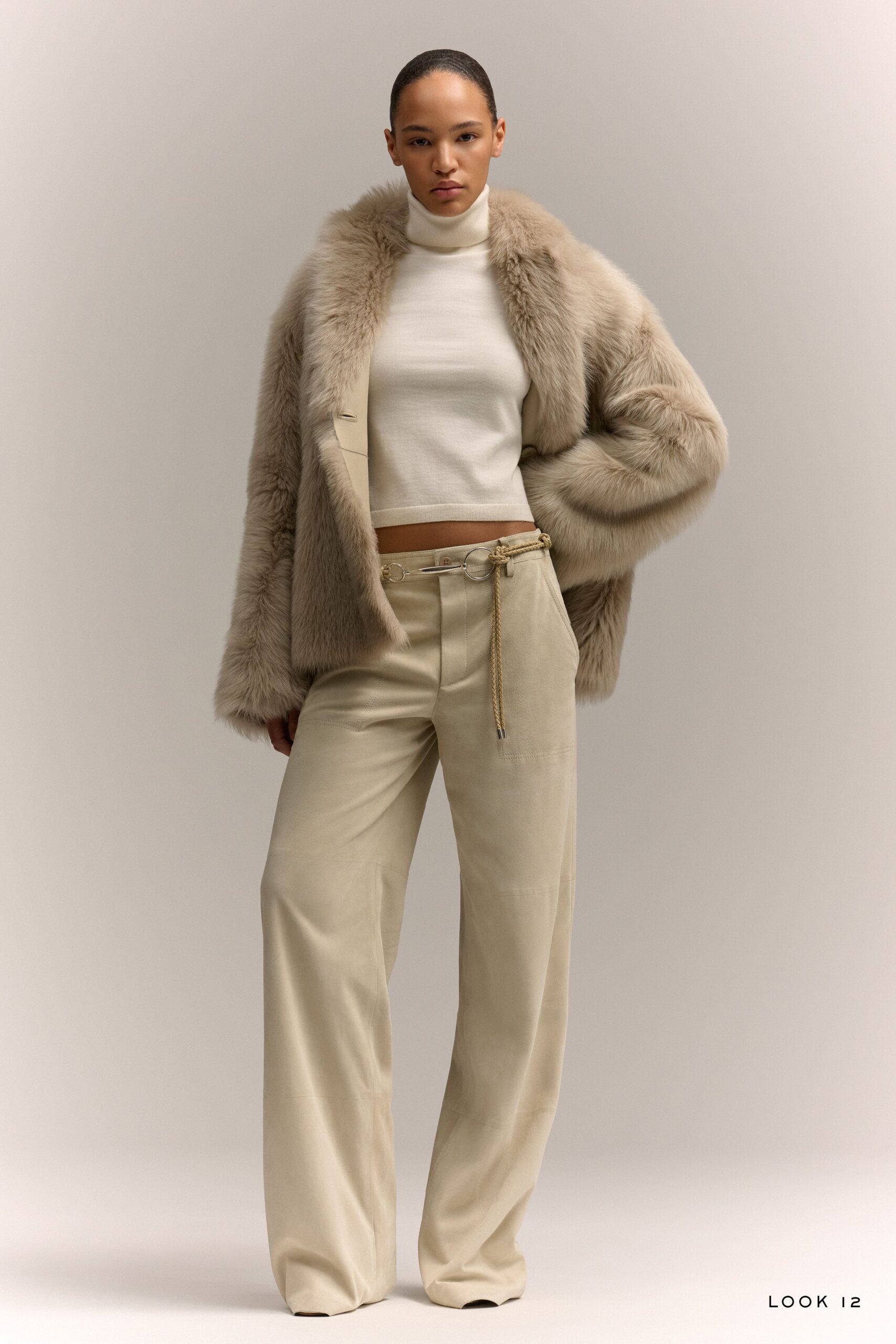 white cropped turtleneck top with beige pants and brown fur coat